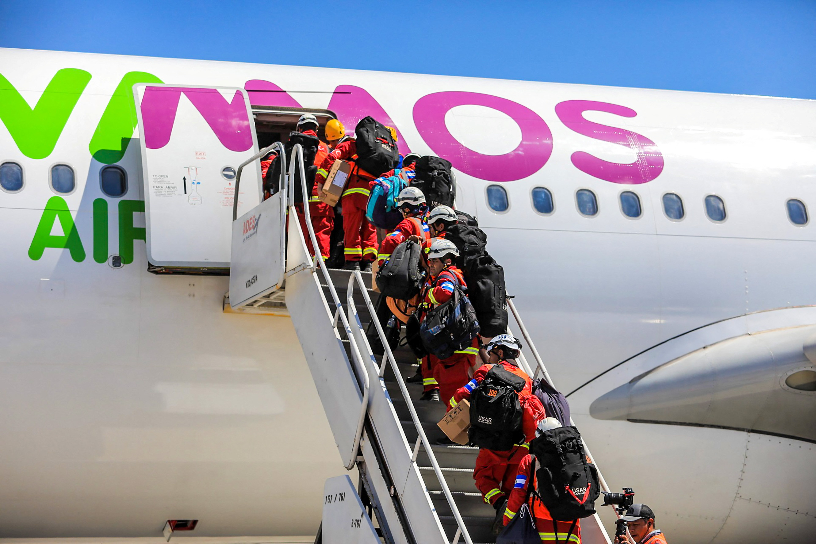 Members of El Salvador's Urban Search And Rescue Team board a plane to Turkey to assist in rescue efforts in San Luis Talpa, El Salvador, on Wednesday.