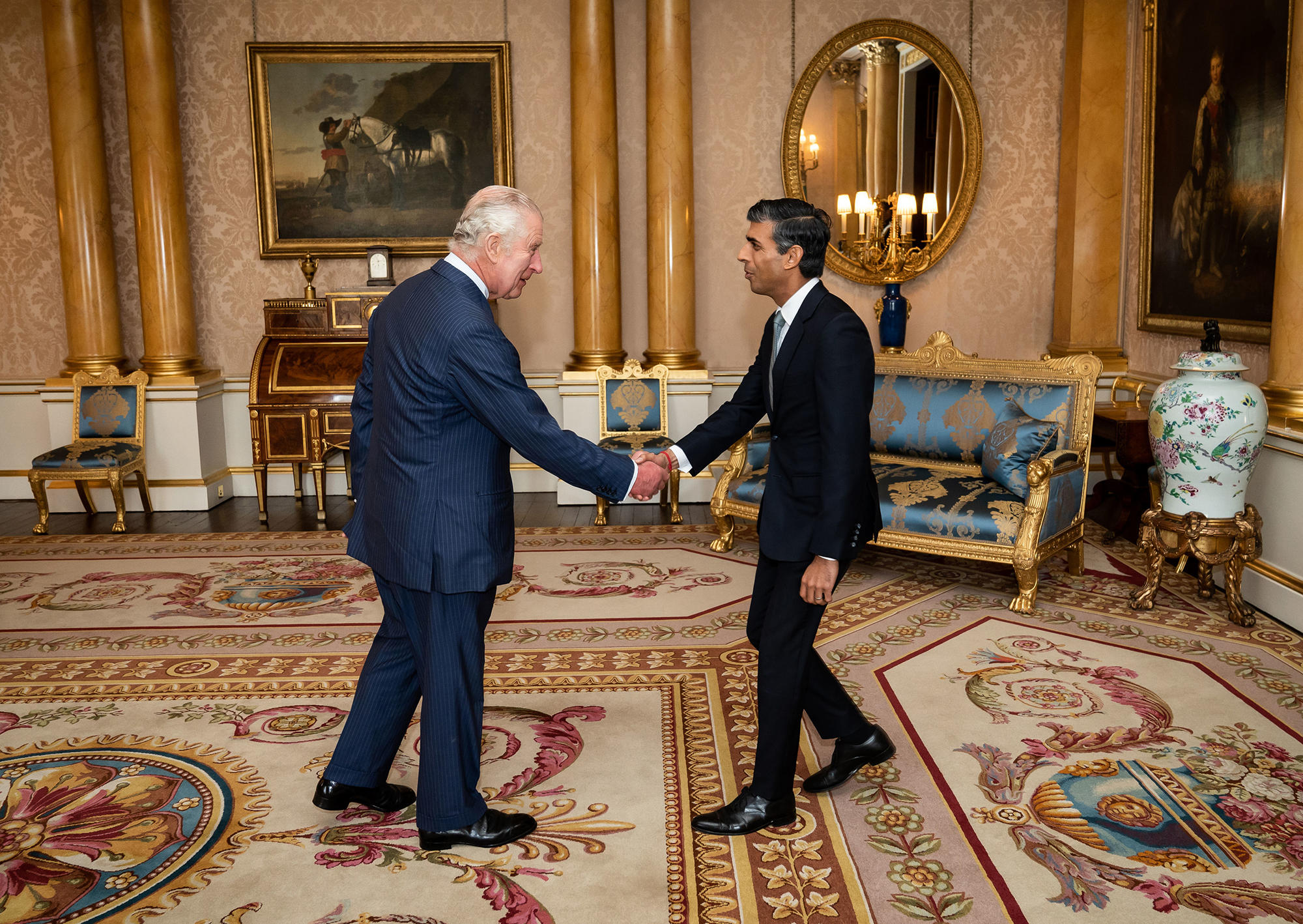 King Charles III welcomes Rishi Sunak during an audience at Buckingham Palace, where he invited the newly elected leader of the Conservative Party to become Prime Minister and form a new government on Tuesday in London.
