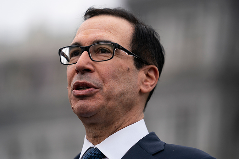 Treasury Secretary Steven Mnuchin talks to reporters at the White House, Friday, March 13.