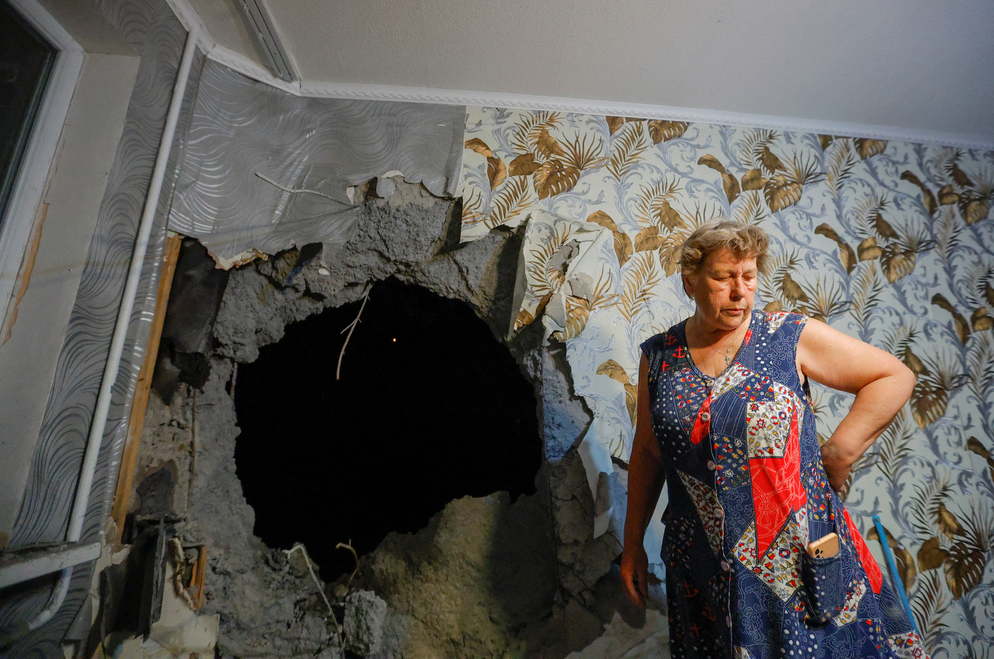 Irina Barkhatova, 68, checks damage in her apartment that was hit by shelling in Donetsk on Sunday.