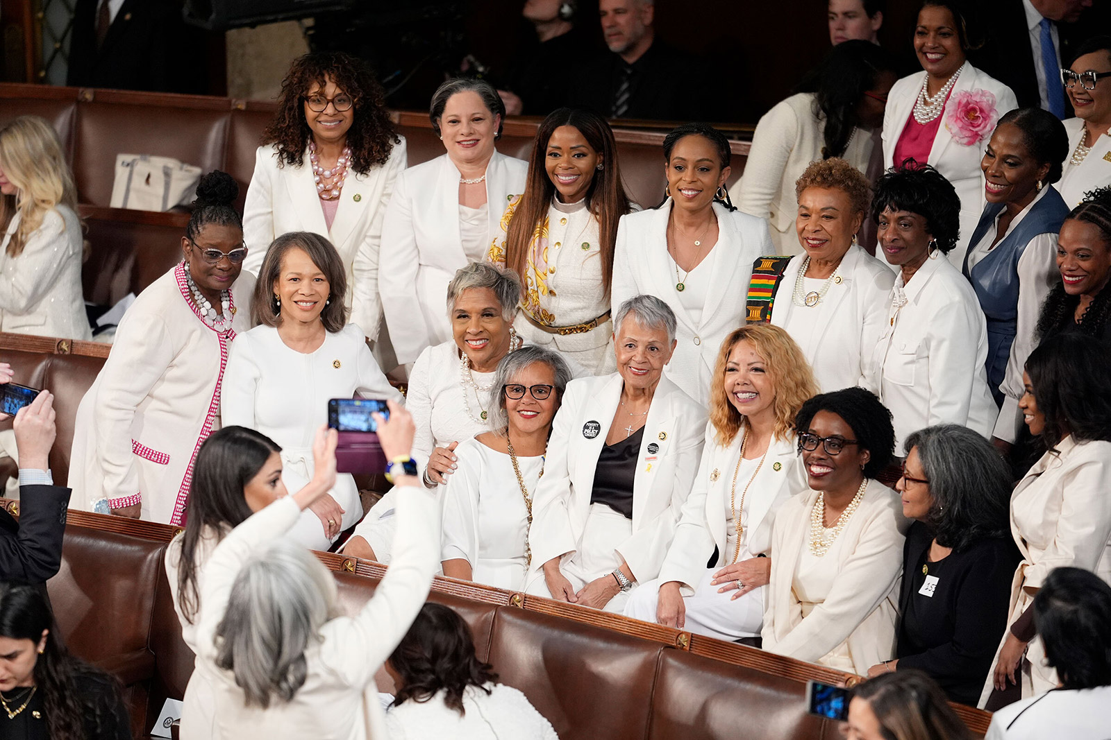 Members of the Democratic caucus wear white for woman's rights before Biden's address.