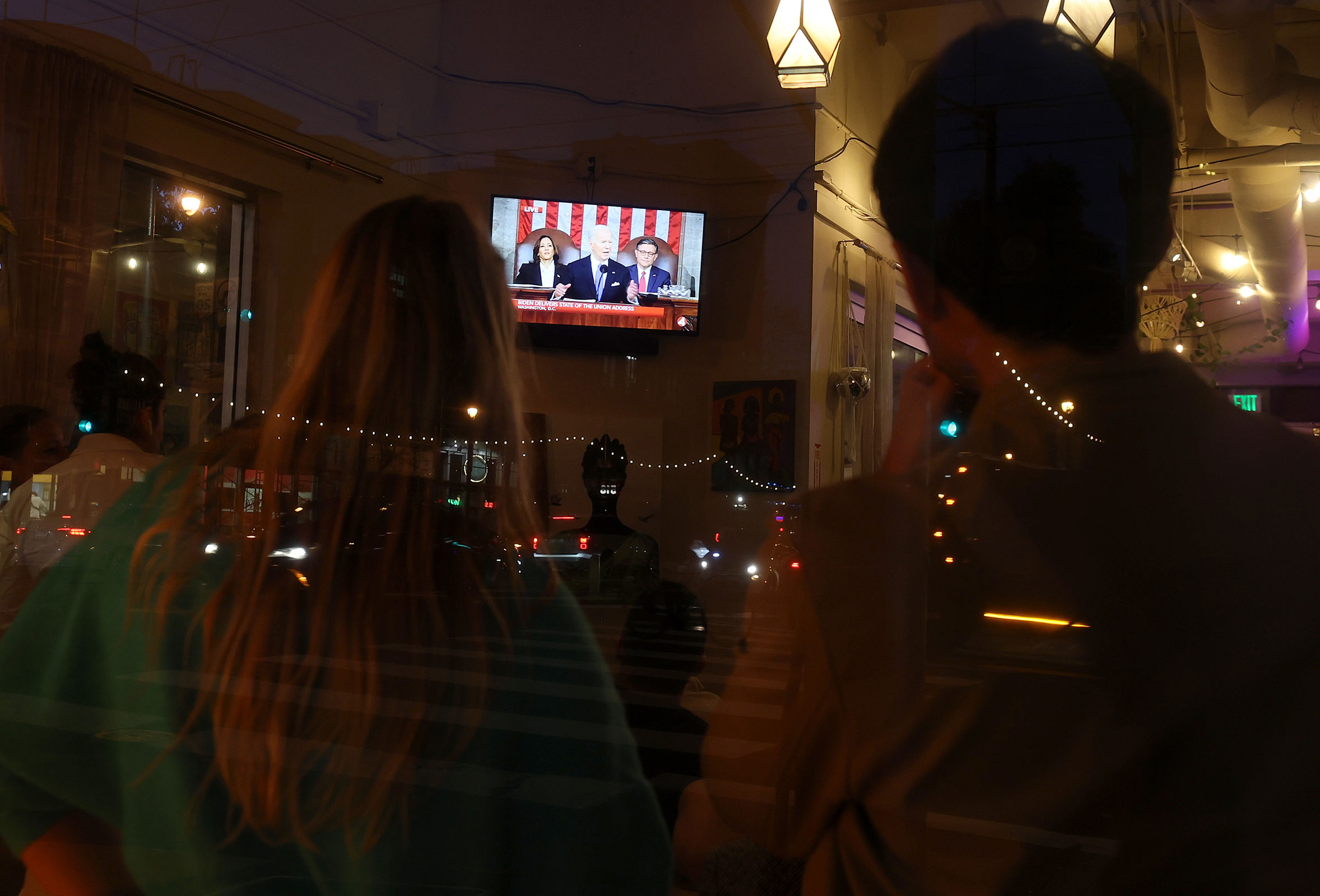 People watch President Joe Biden deliver the State of the Union during a State of the Union watch party at Manny's on March 7 in San Francisco, California.