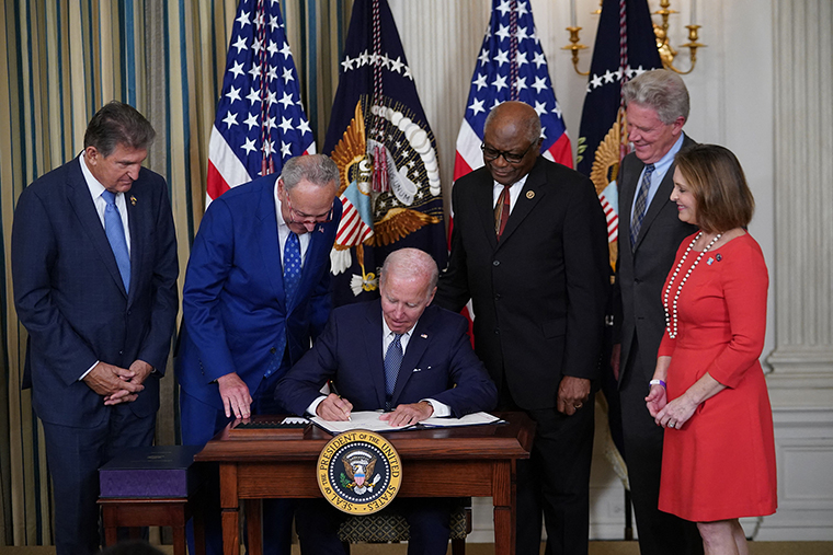 Biden signs the Inflation Reduction Act of 2022 into law during a ceremony in the State Dining Room of the White House in Washington, D.C., on Tuesday, August 16.