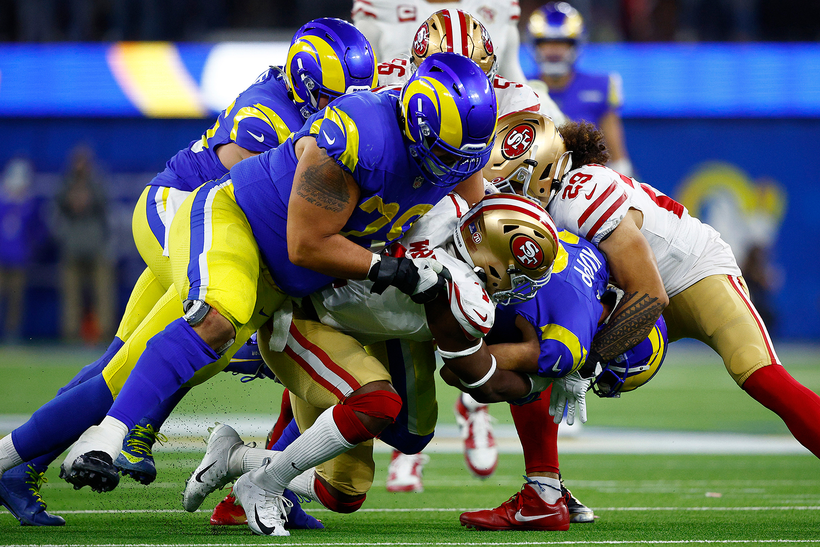 Cooper Kupp #10 of the Los Angeles Rams is tackled by Jimmie Ward #1 and Talanoa Hufanga #29 of the San Francisco 49ers in the fourth quarter during the NFC Championship Game at SoFi Stadium on January 30, in Inglewood, California.