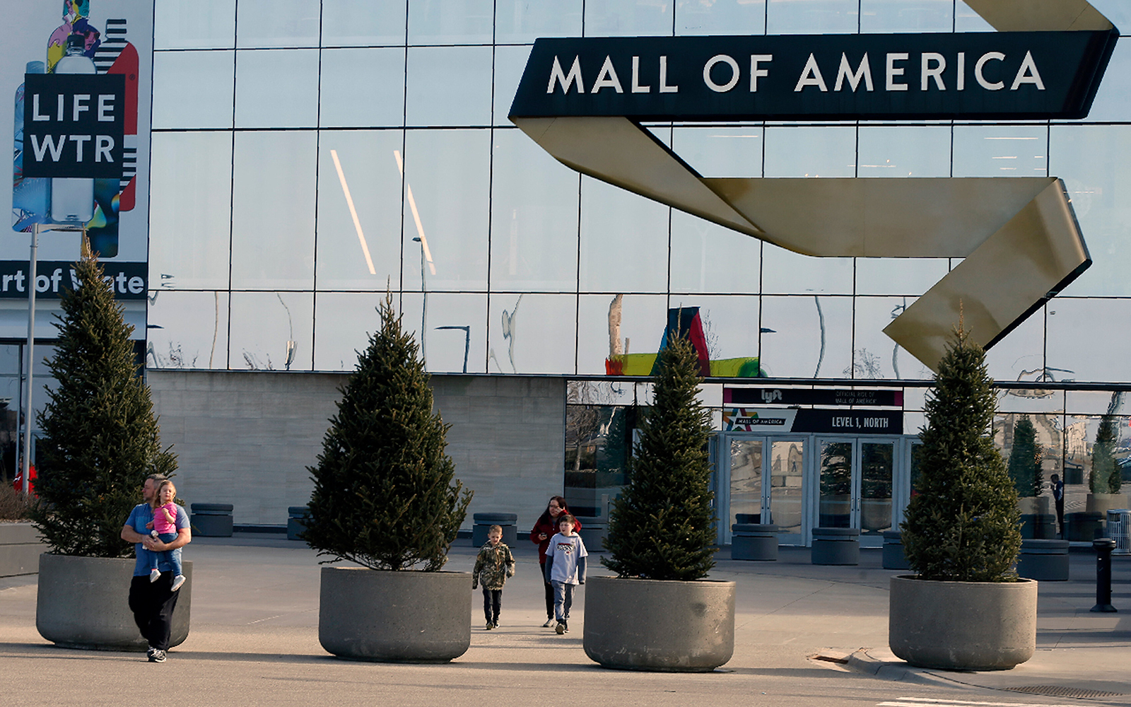 Shoppers, visitors and employees leave the Mall of America in Bloomington, Minnesota, on Tuesday, March 17, moments before it closed temporarily due to coronavirus.