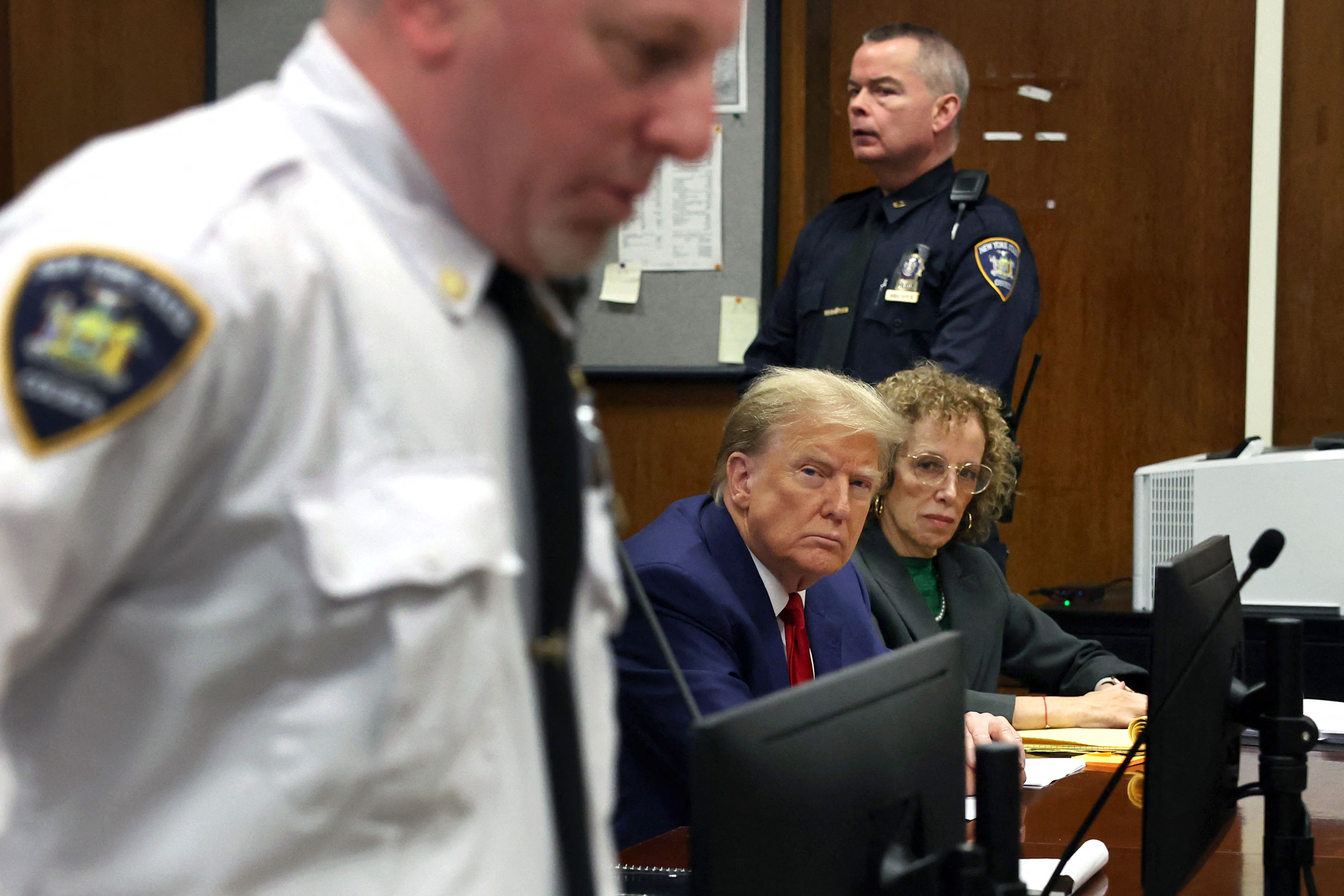 Former President Donald Trump and attorney Susan Necheles sit in court before the hearing begins on Monday.