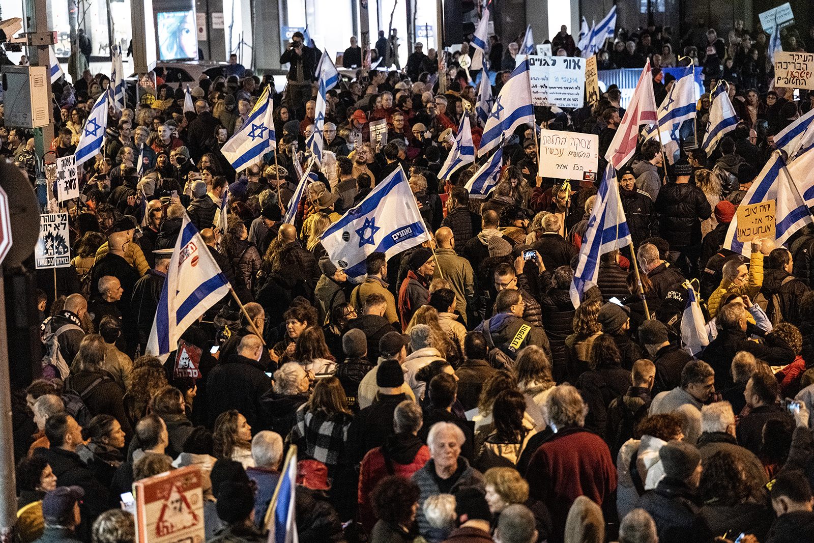 Protesters gather to stage a demonstration demanding the resignation of the government and the holding of early elections, in Tel Aviv, Israel on February 3.