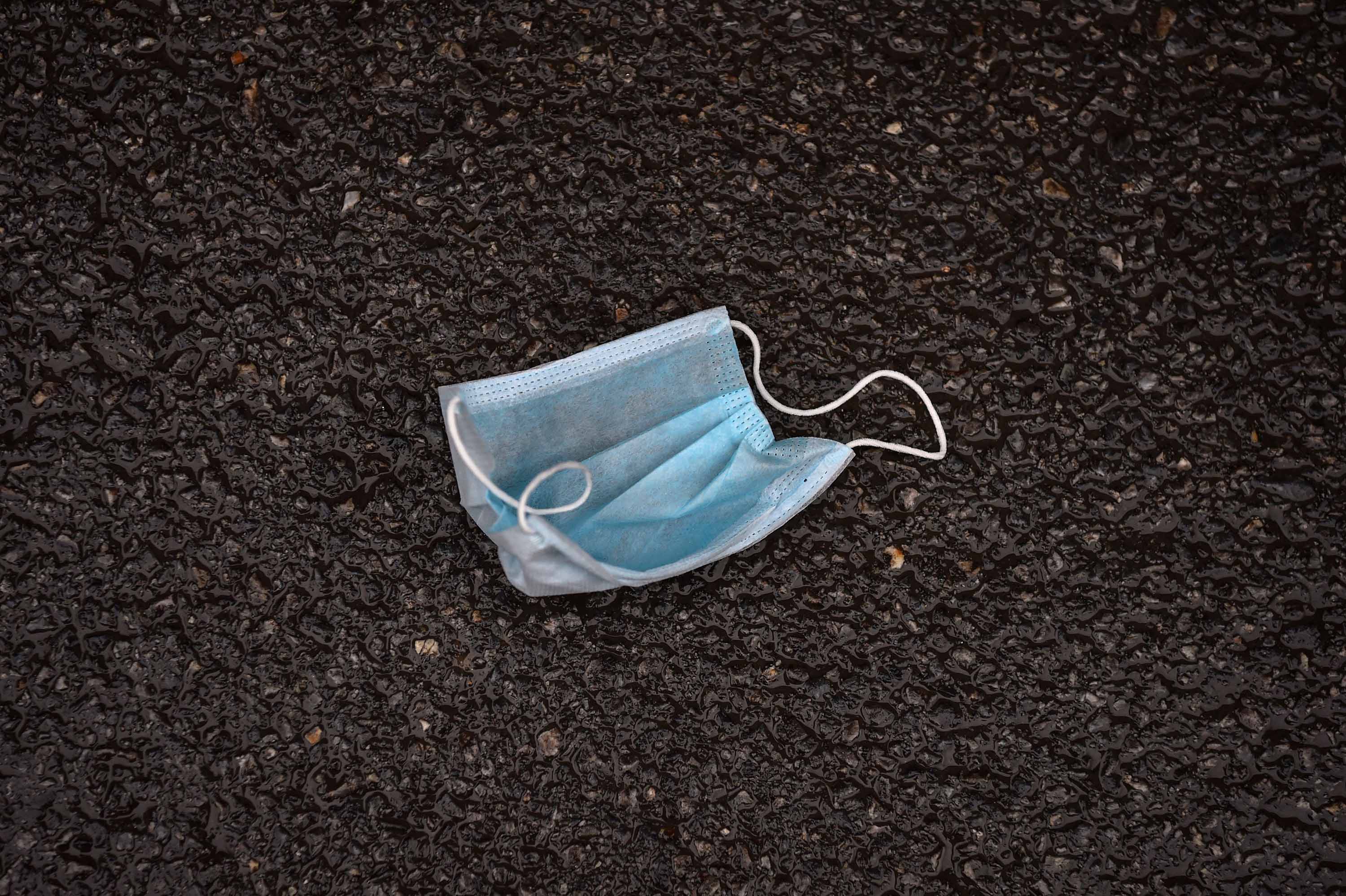 A discarded face mask is pictured on a street in Wuhan on January 26.