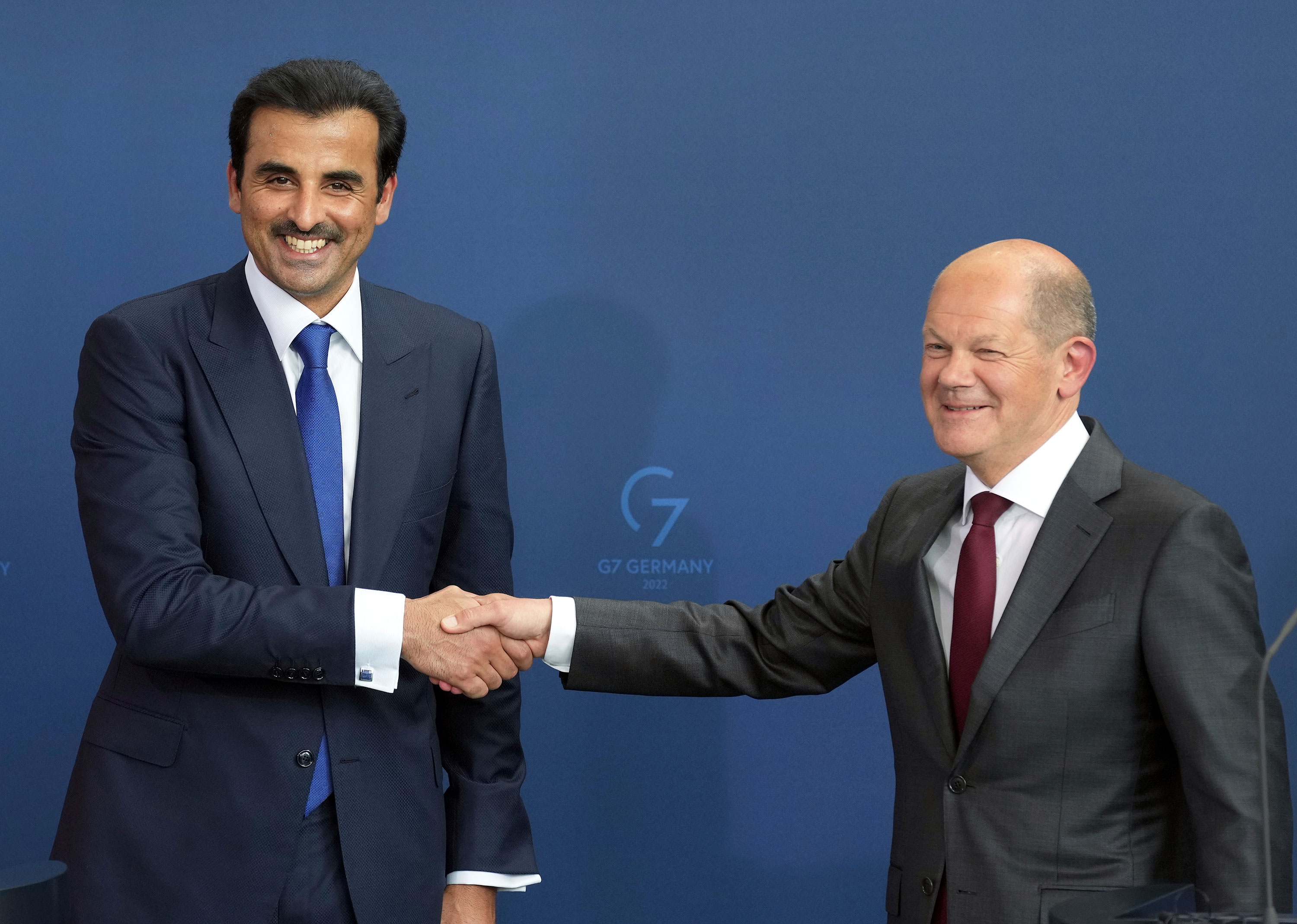 The Emir of Qatar Sheikh Tamim bin Hamad Al Thani and German Chancellor Olaf Scholz shake hands after a joint press conference in Berlin on Friday.