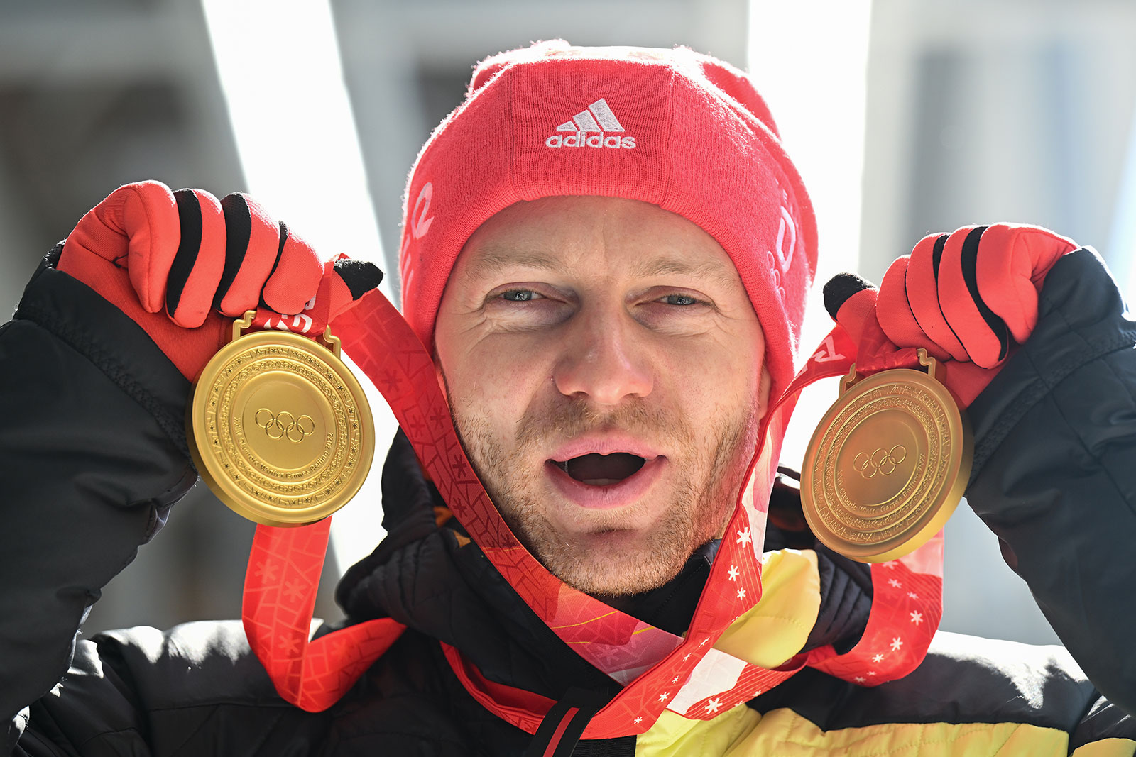German bobsledder Francesco Friedrich holds up his gold medals from the two- and four-man events on February 20.