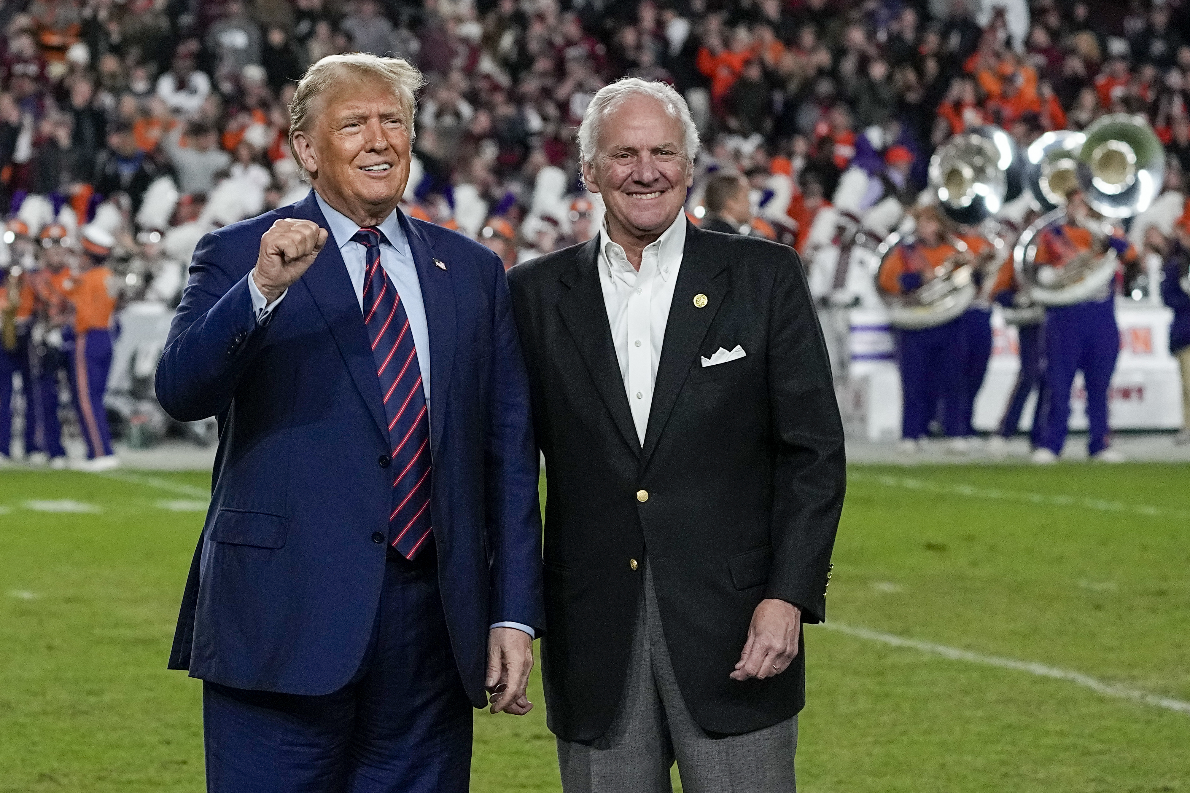 Former President Donald Trump gestures with South Carolina Gov. Henry McMaster during halftime at an NCAA football game between the University of South Carolina and Clemson University in Columbia, South Carolina, on November 25.