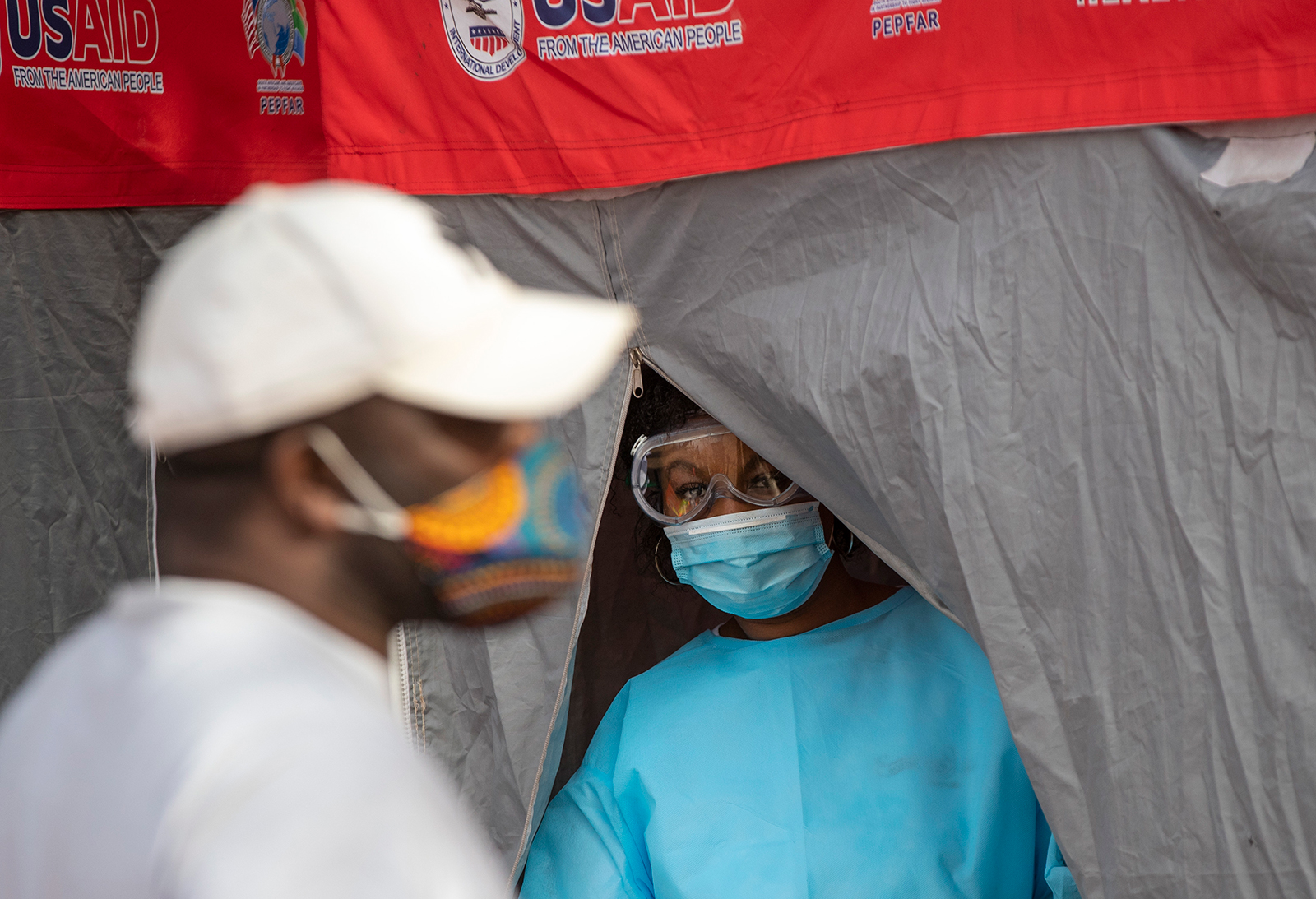A heath worker looks on during the screening and testing campaign aimed to combat the spread of COVID-19 at Tembisa township in Johannesburg, South Africa, on Tuesday, May 19.