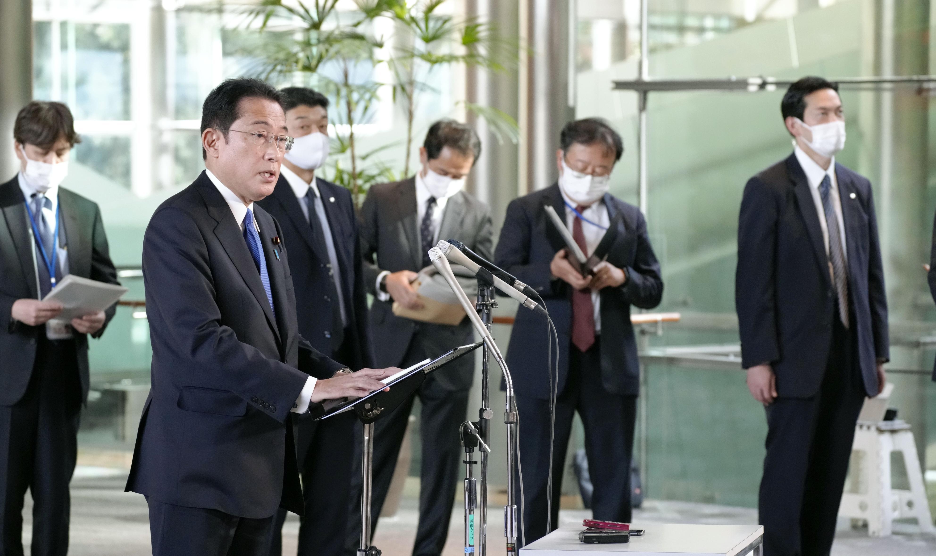 Japanese Prime Minister Fumio Kishida speaks to reporters at his office in Tokyo on Nov. 29, 2021, about border controls to keep out the new Omicron variant of the coronavirus.