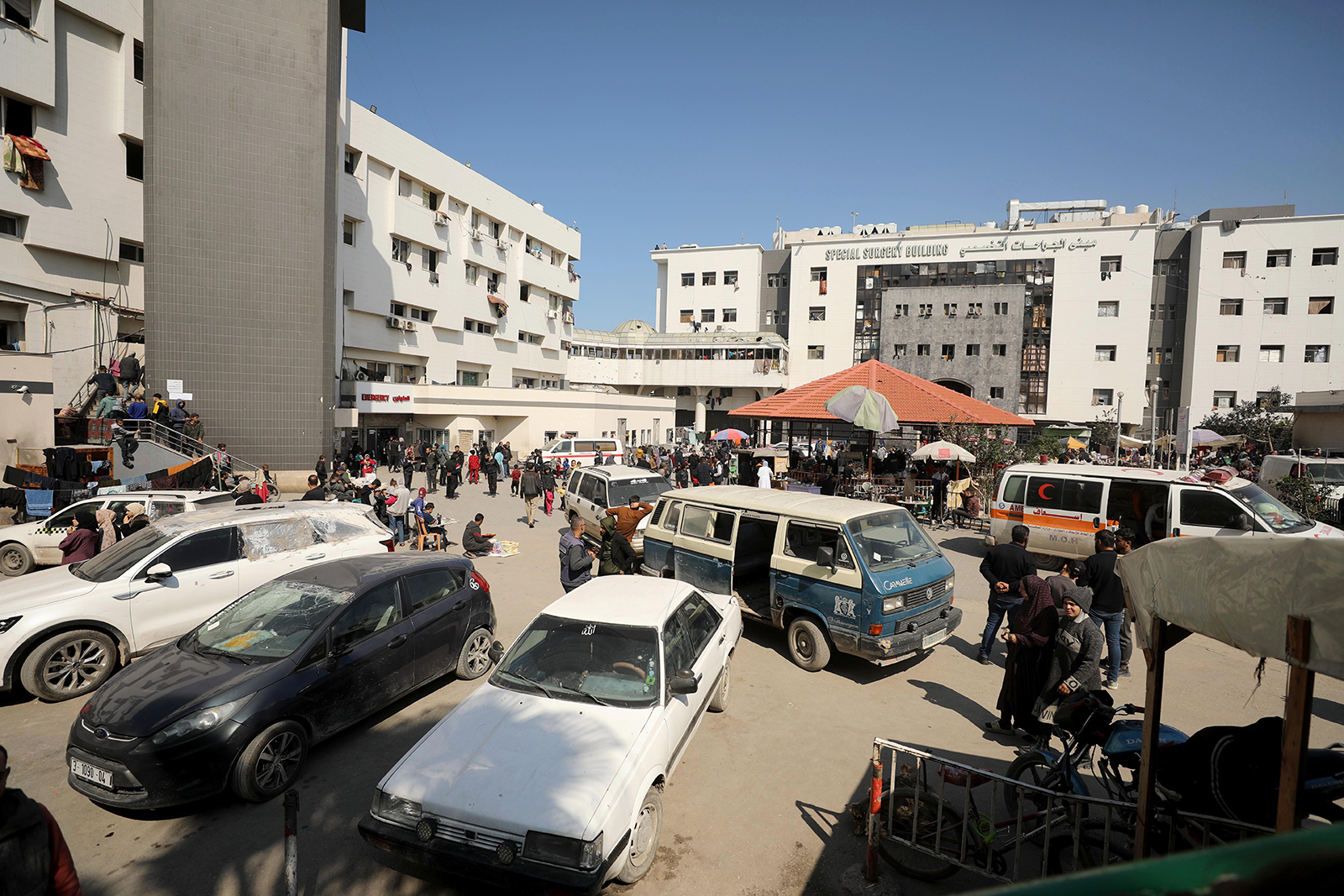 Palestinians arrive to the partially demolished Al-Shifa Hospital to take shelter in Gaza on February 22.