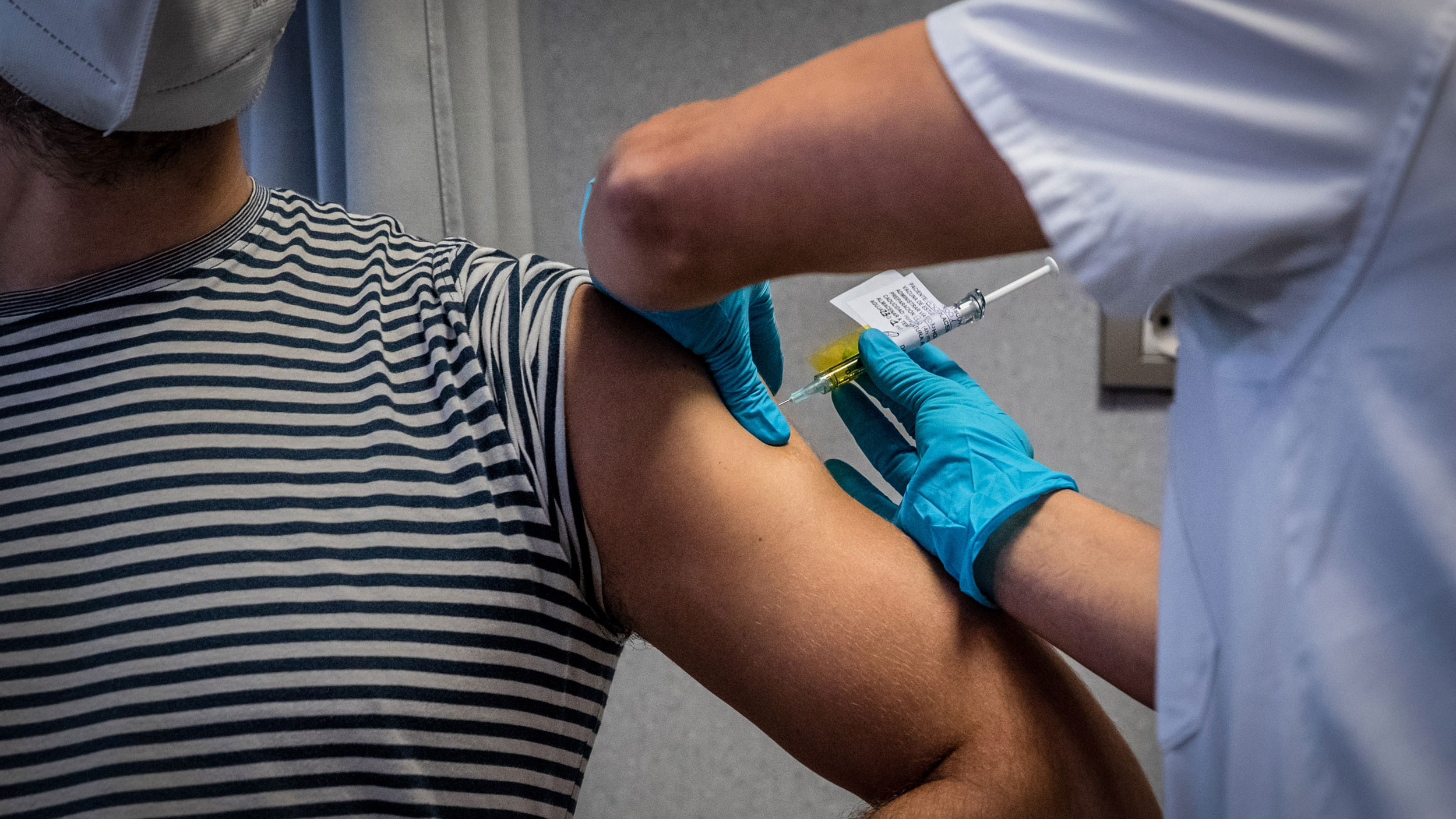 A medical worker in Barcelona, Spain, administers an injection December 17 during a trial of the Johnson & Johnson Covid-19 vaccine.