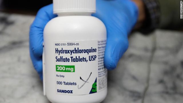 A pharmacist shows a bottle of hydroxychloroquine in Oakland, California, on April 6.