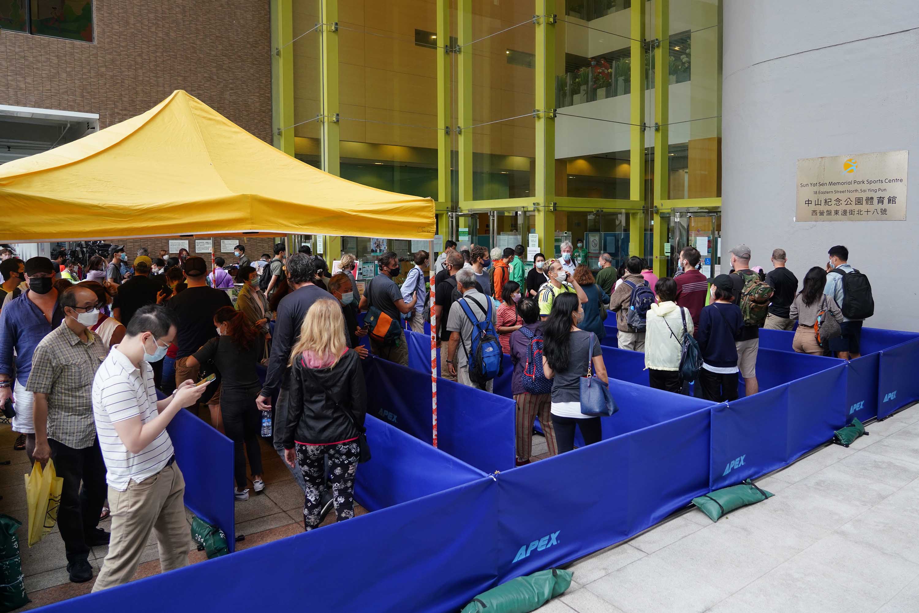 People queue to receive a Covid-19 vaccine at Sun Yat Sen Memorial Park Sports Center in Hong Kong, on April 5. 
