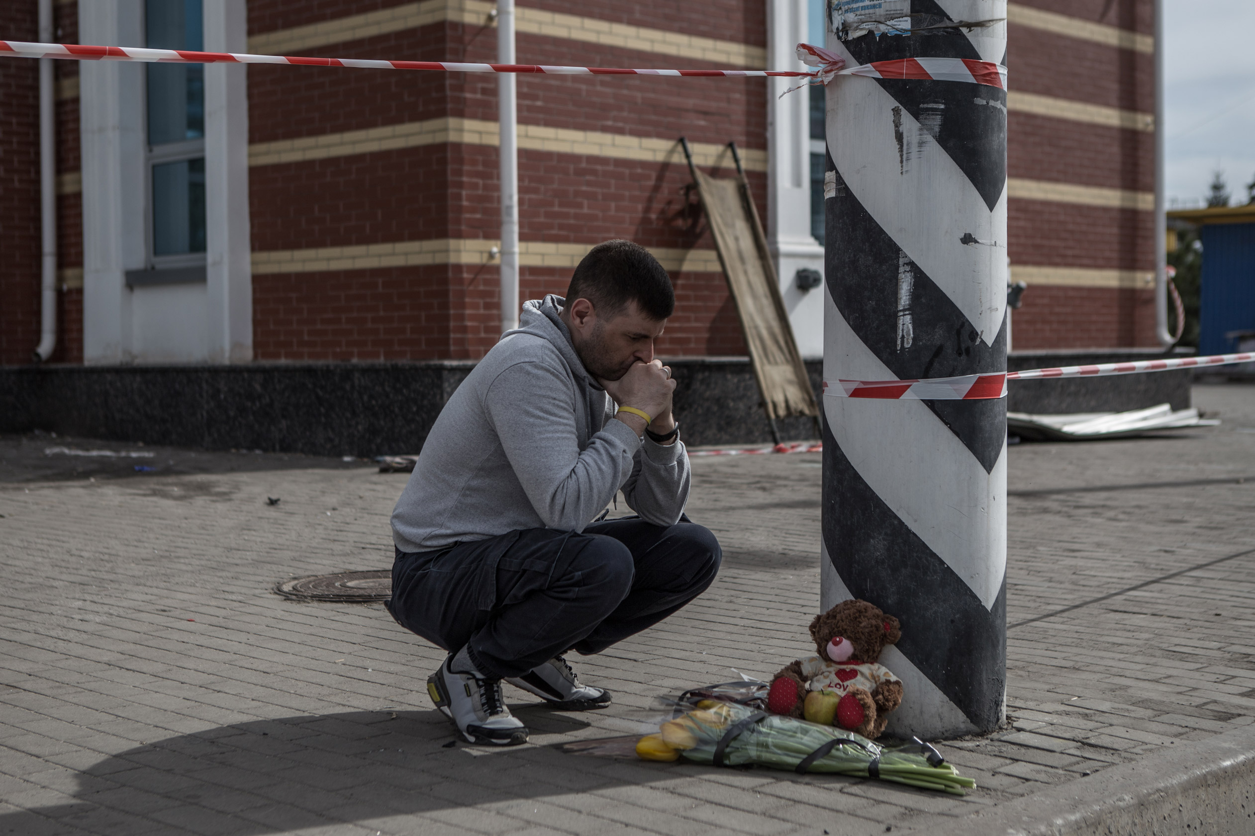 On April 9, a man lays flowers for the victims of the missile attack at the Kramatorsk railway station.