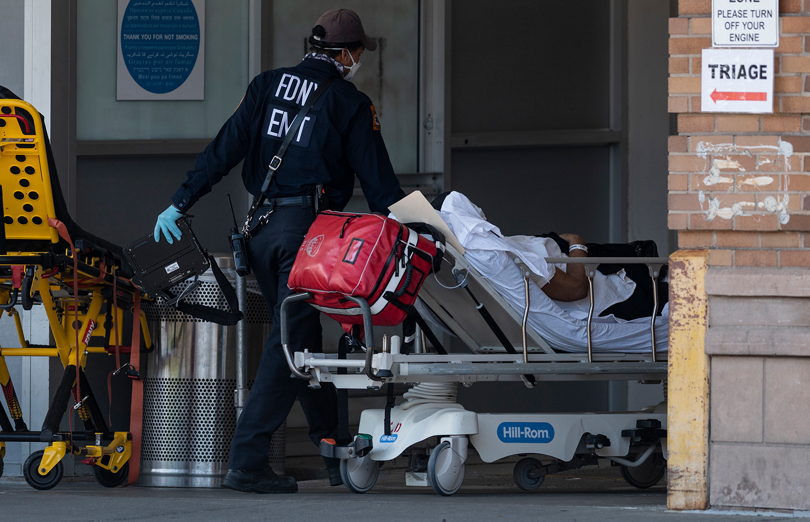 Medical workers transport a patient outside a special COVID-19 illness area at Maimonides Medical Center in Brooklyn, New York on May 17.