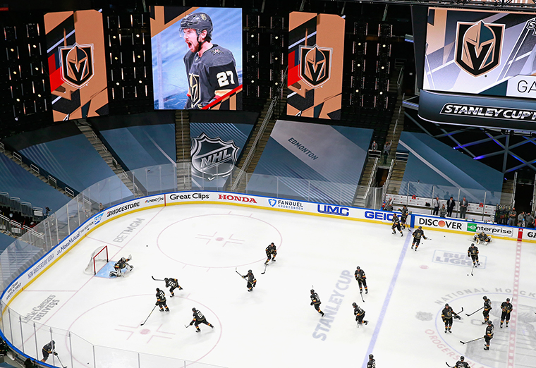 The Vegas Golden Knights skate in warm-ups under team promotional signs prior to the game against the Vancouver Canucks in Game One of the Western Conference Second Round during the 2020 NHL Stanley Cup Playoffs at Rogers Place on August 23, 2020 in Edmonton, Alberta, Canada. 