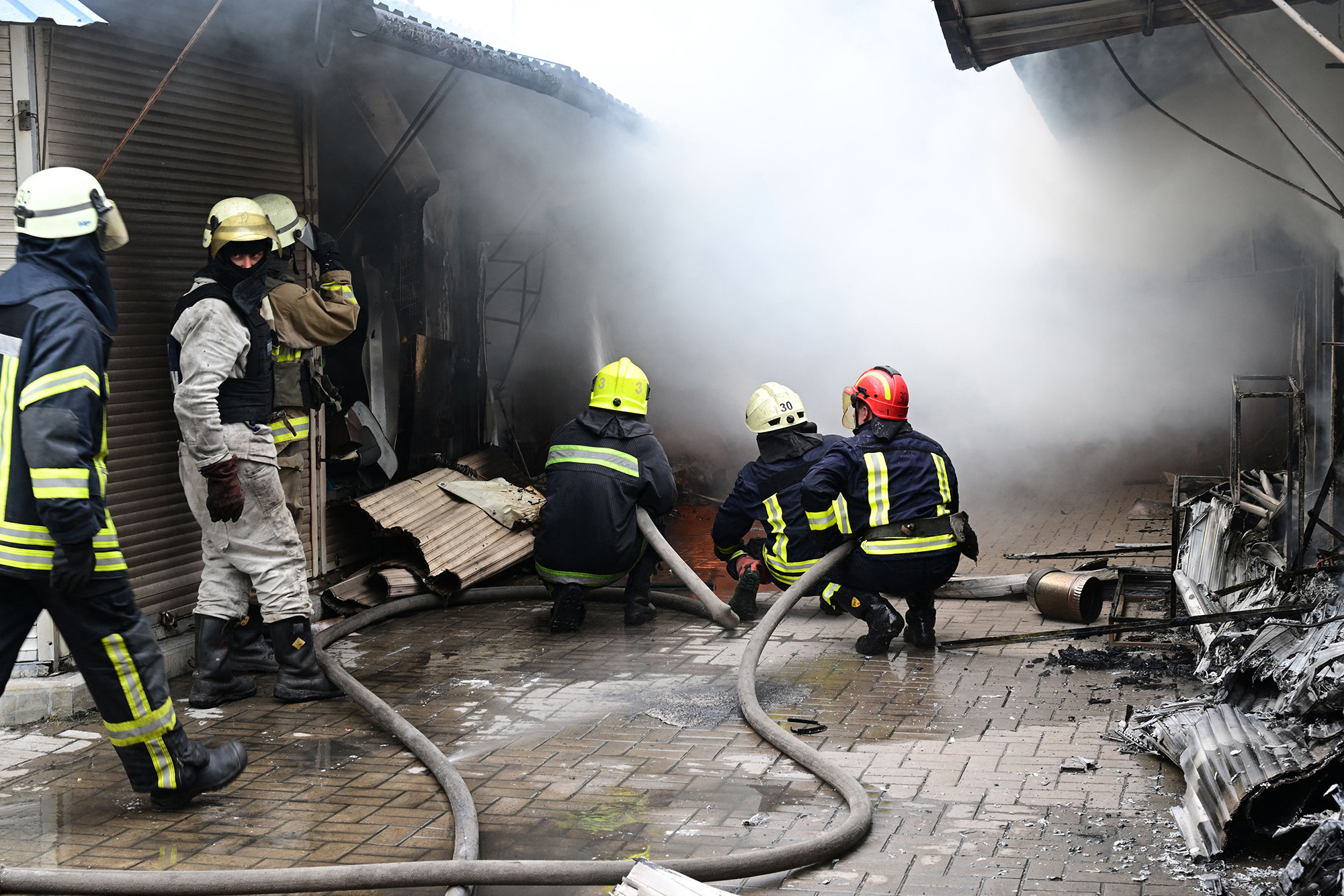 Firefighters work to control flames at the central market of Sloviansk, following a suspected Russian missile attack on July 5.