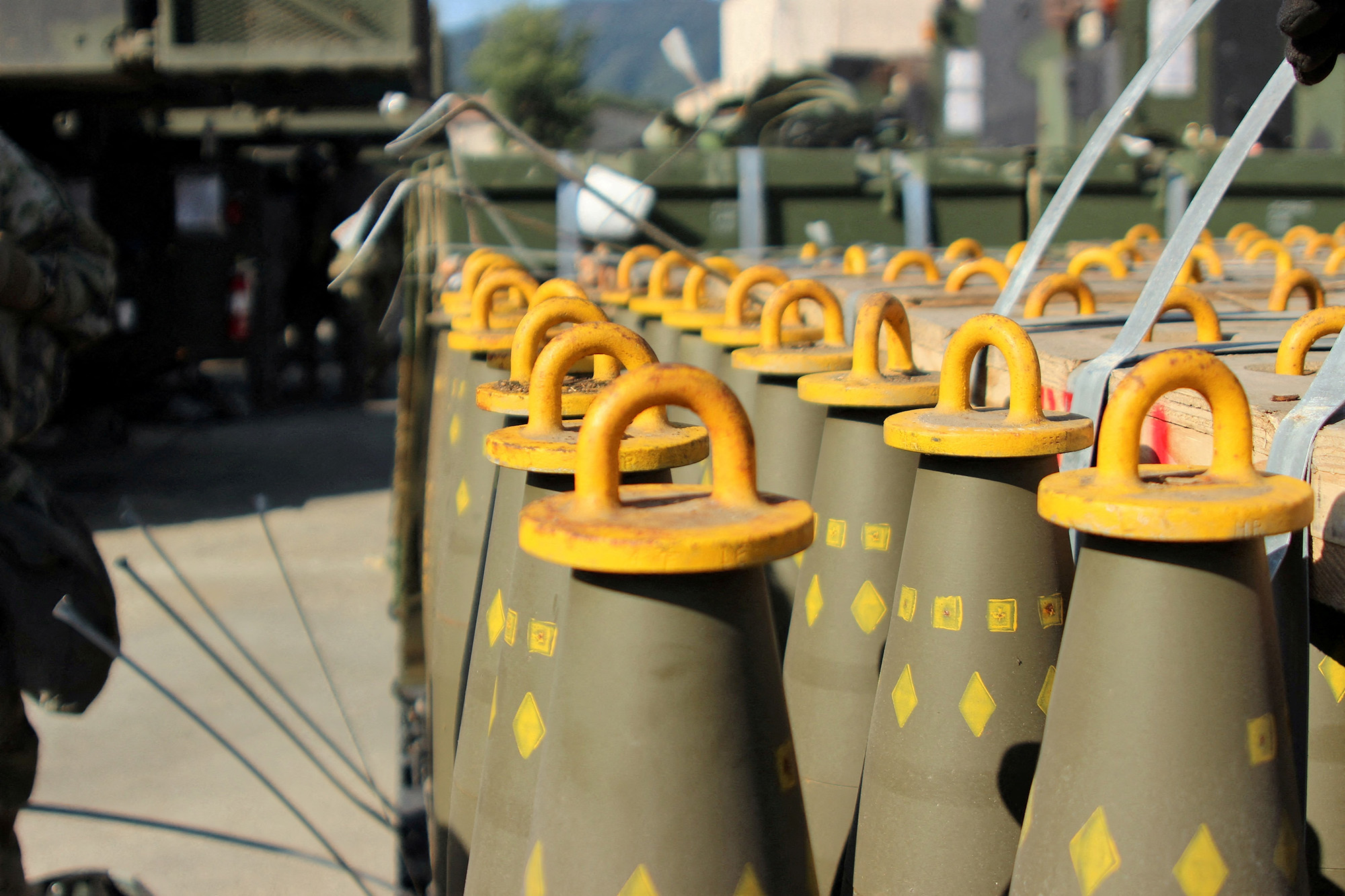 Dozens of 155mm Base Burn Dual Purpose Improved Conventional Munitions (DPICM) rounds wait to be loaded at a U.S. Army motor pool at Camp Hovey, South Korea on September 20, 2016.