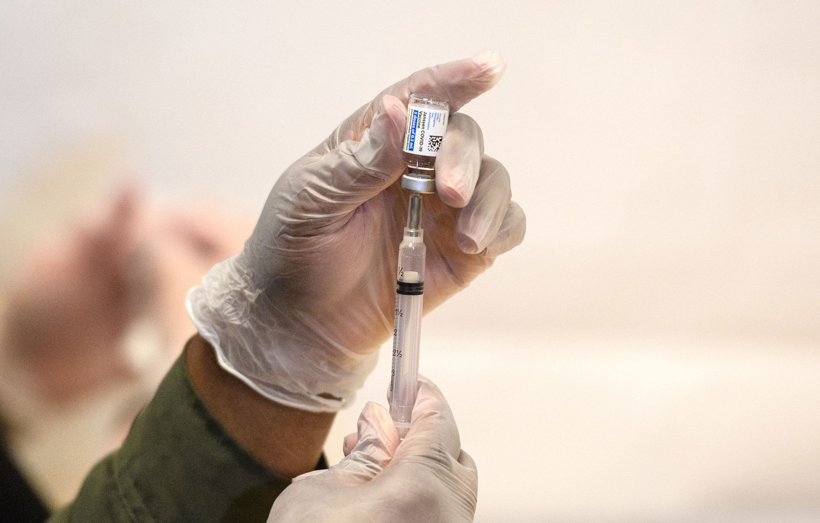 A healthcare worker prepares a syringe with a vial of the J&J/Janssen Covid-19 vaccine at a temporary vaccination site at Grand Central Terminal train station on May 12 in New York City. 