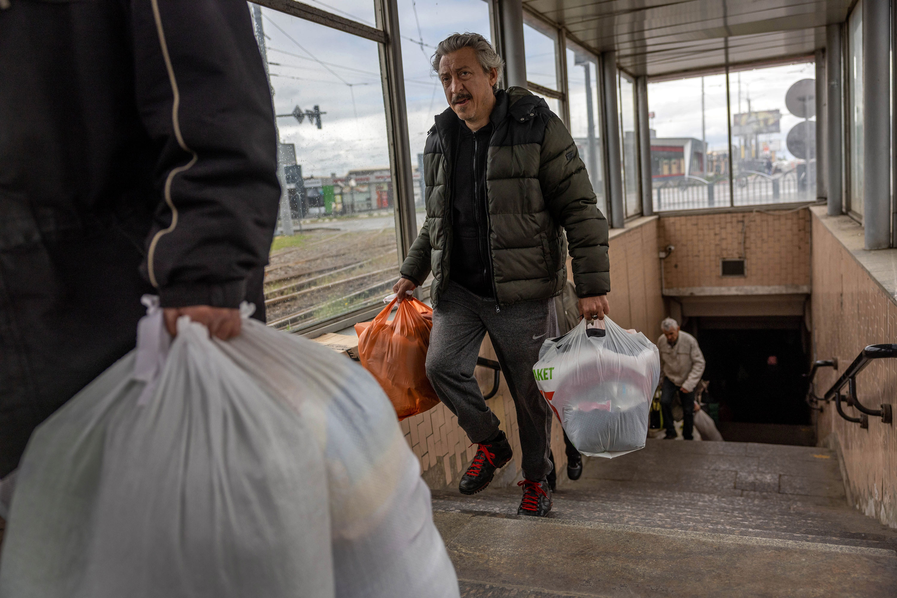 People displaced by Russian shelling depart a metro station where many have been living underground for months in Kharkiv, on Sunday, May 22.