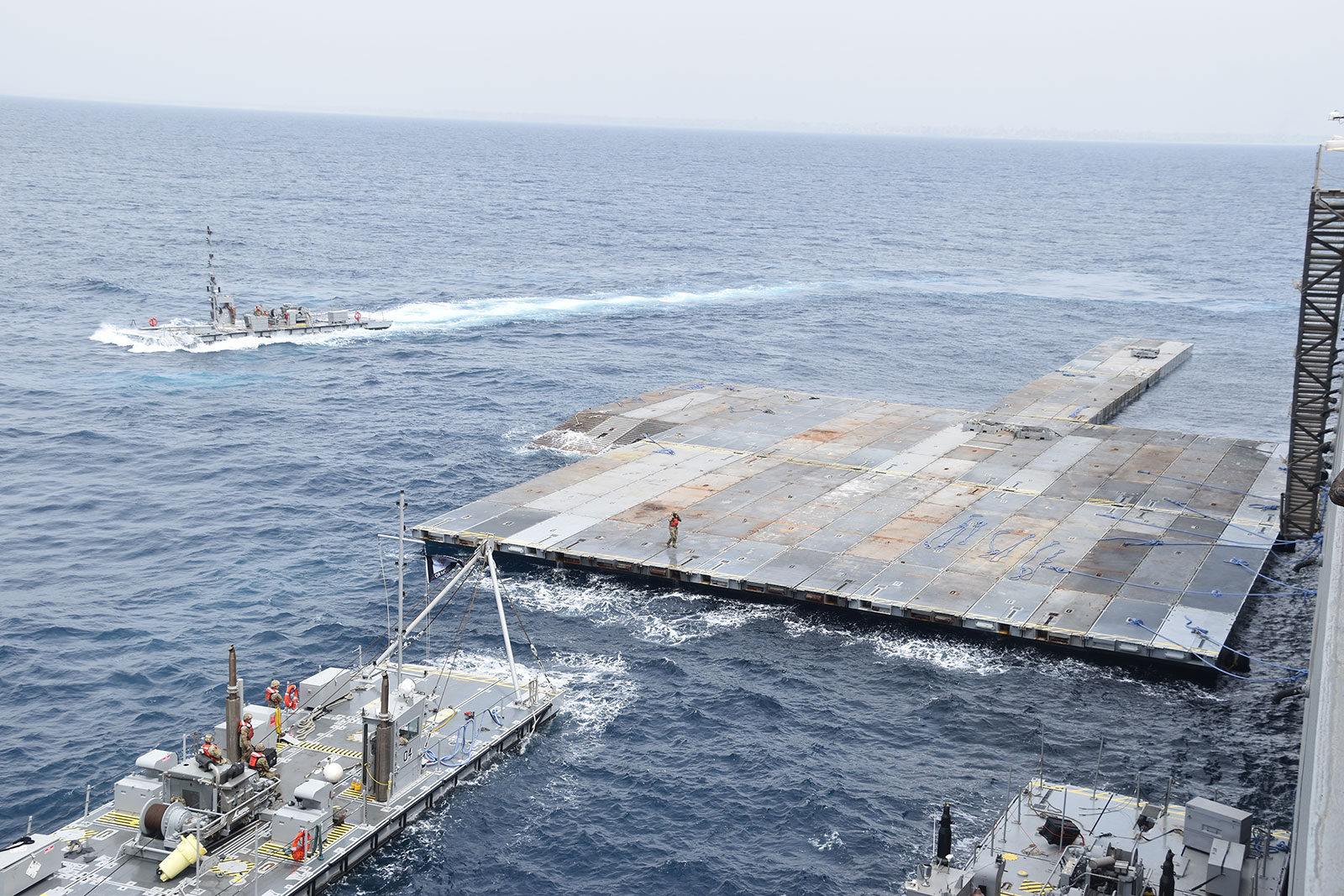 US Army soldiers assemble the Roll-On, Roll-Off Distribution Facility (RRDF), or floating pier, off the shore of Gaza in support of Operation Neptune Solace on April 26.