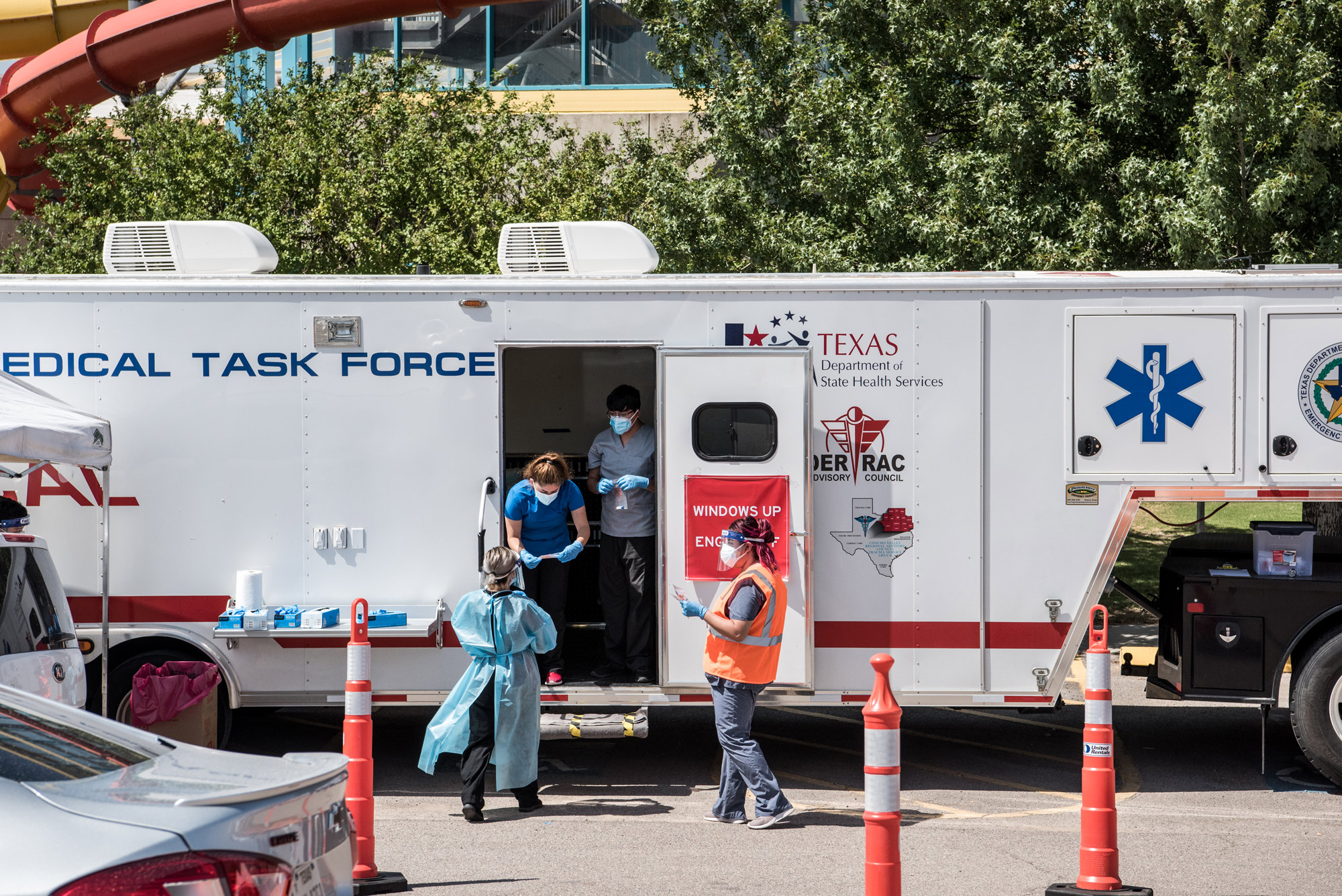Nurses conduct coronavirus testing at a drive-thru site at SISD Student Activities Complex on July 21 in El Paso, Texas. 