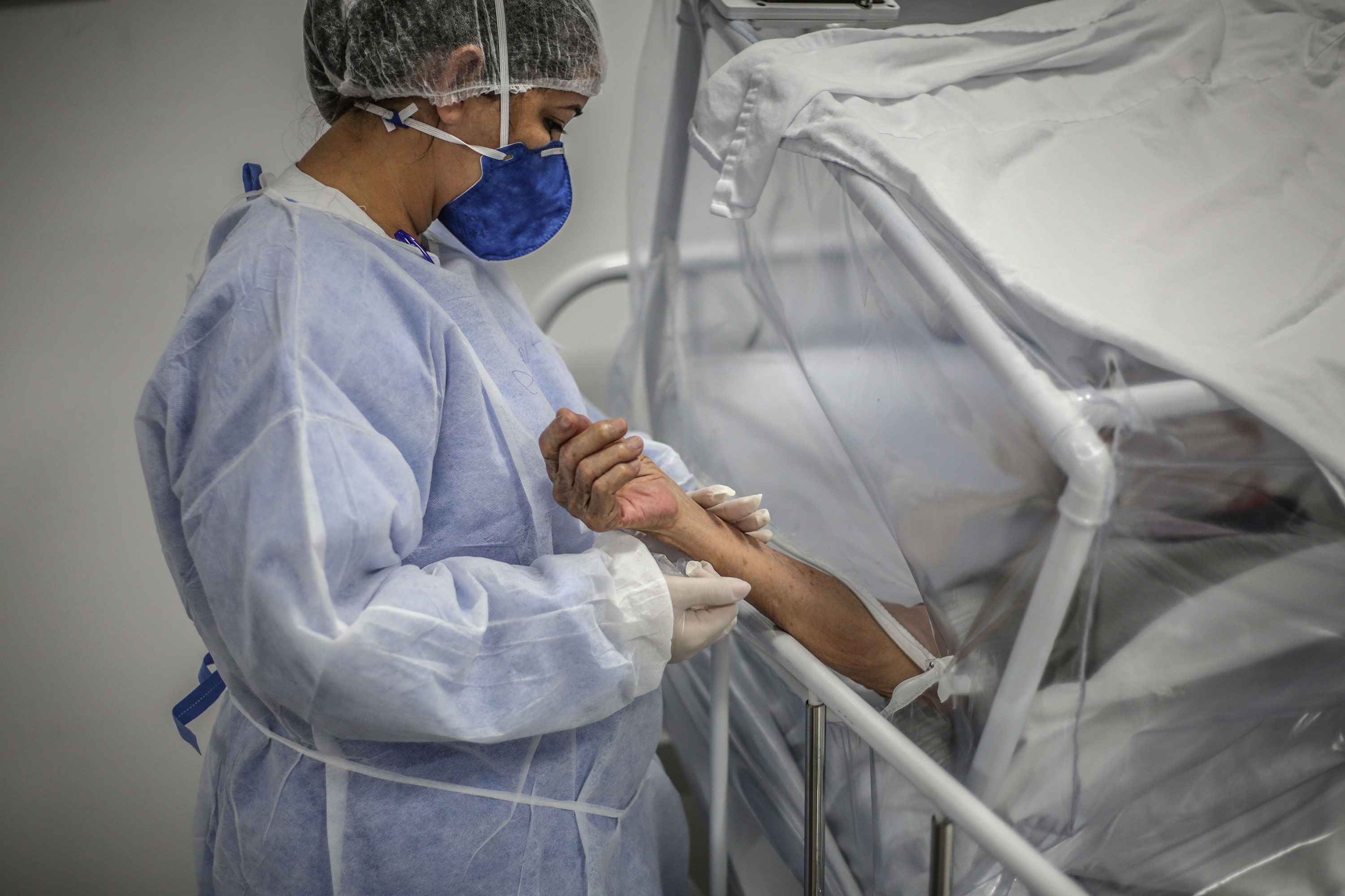 A nurse tends to a coronavirus patient at the Gilberto Novaes Municipal Field Hospital on May 21 in Manaus, Brazil.