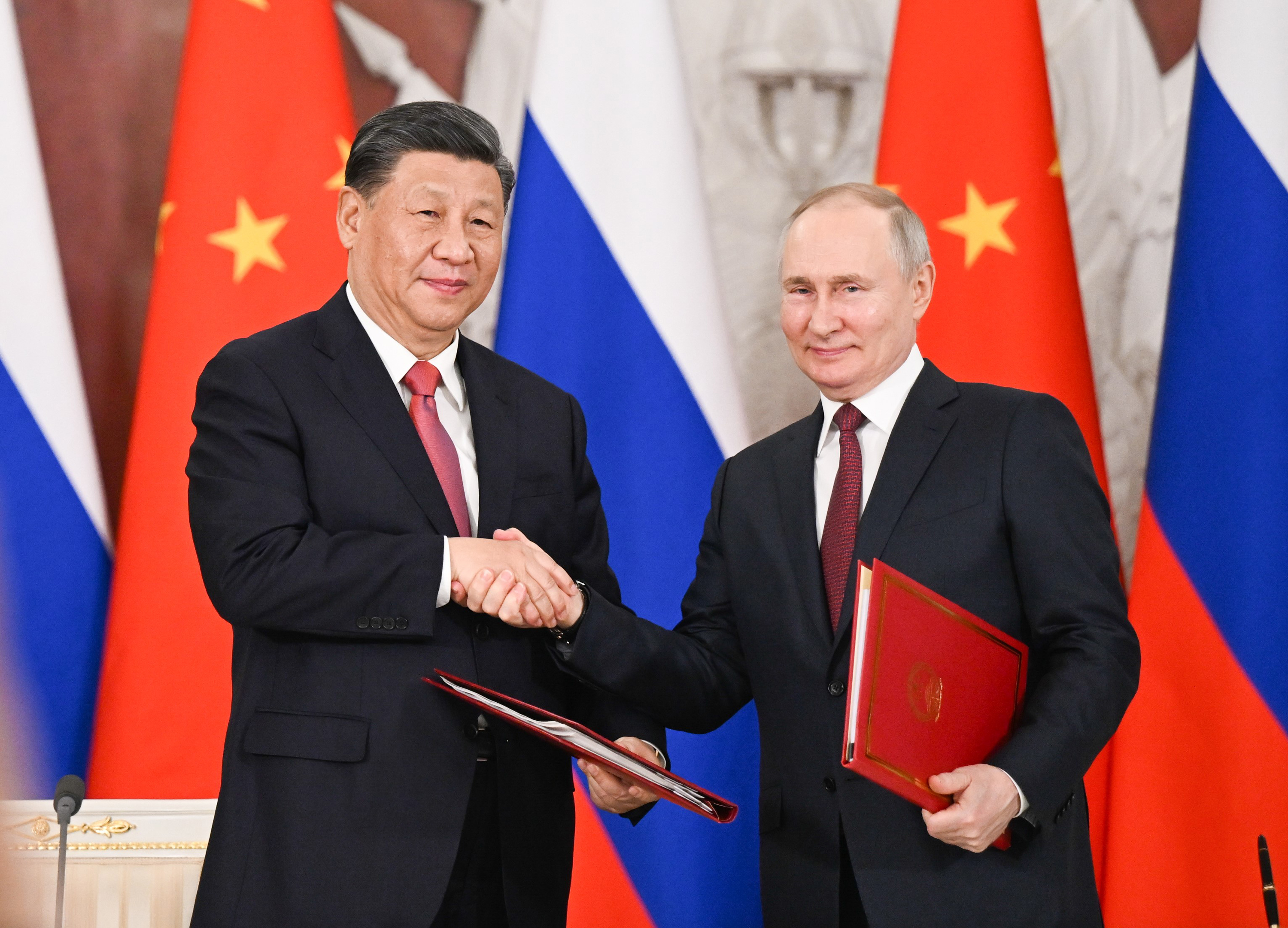 Chinese President Xi Jinping and Russian President Vladimir Putin shake hands during a visit from Xi in Moscow. On Tuesday, Xi held talks with Putin at the Kremlin.