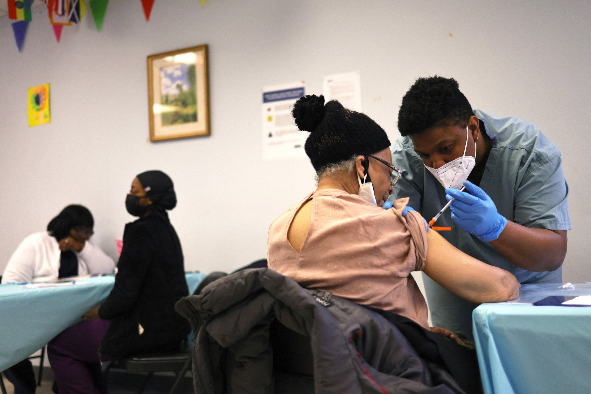 Elizabeth Griffin, 86, is given her first dose of the Moderna coronavirus vaccine by Anya Harris at Red Hook Neighborhood Senior Center on February 22 in New York City. 