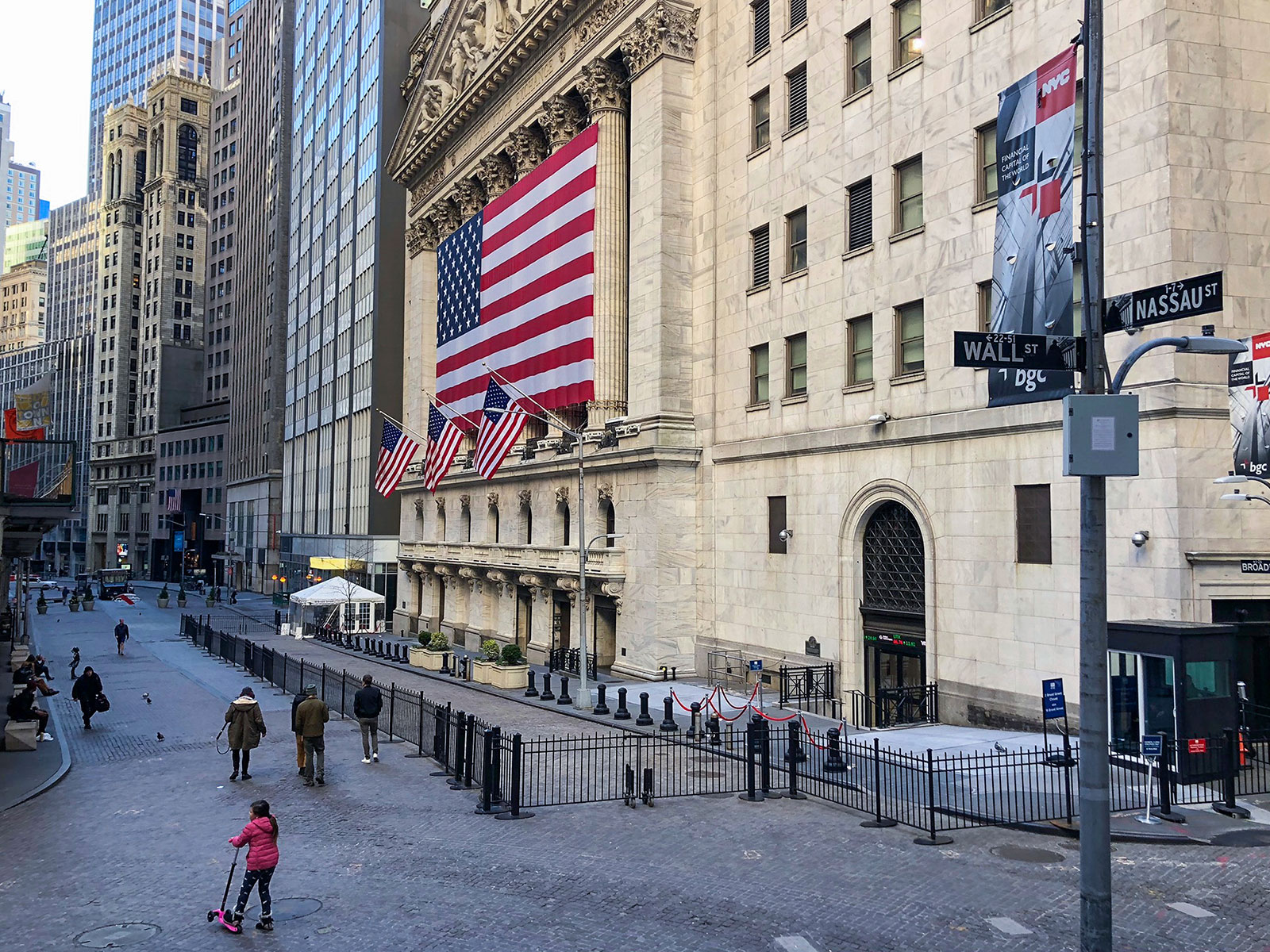Pedestrians walk outside the New York Stock Exchange on March 24.