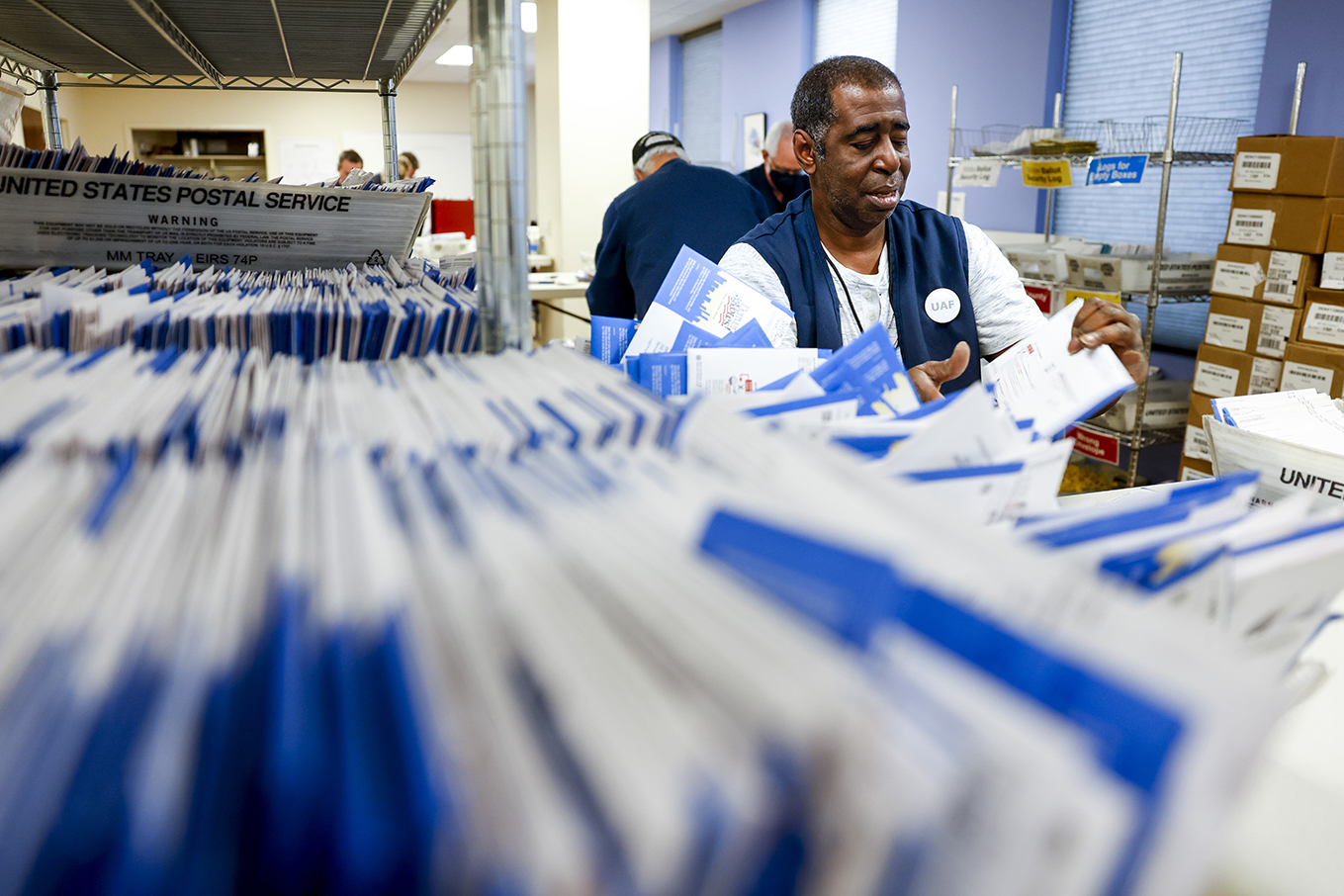 Denver election judge Andre Jefferson sorts ballots at the Denver Elections Division on Tuesday.