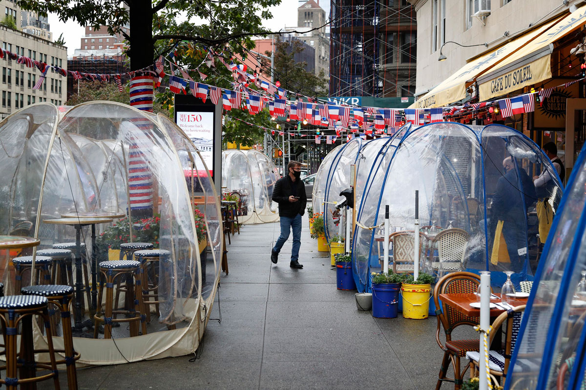 Transparent social distancing bubble tents are set up for diners outside a restaurant in Manhattan, New York on October 13.