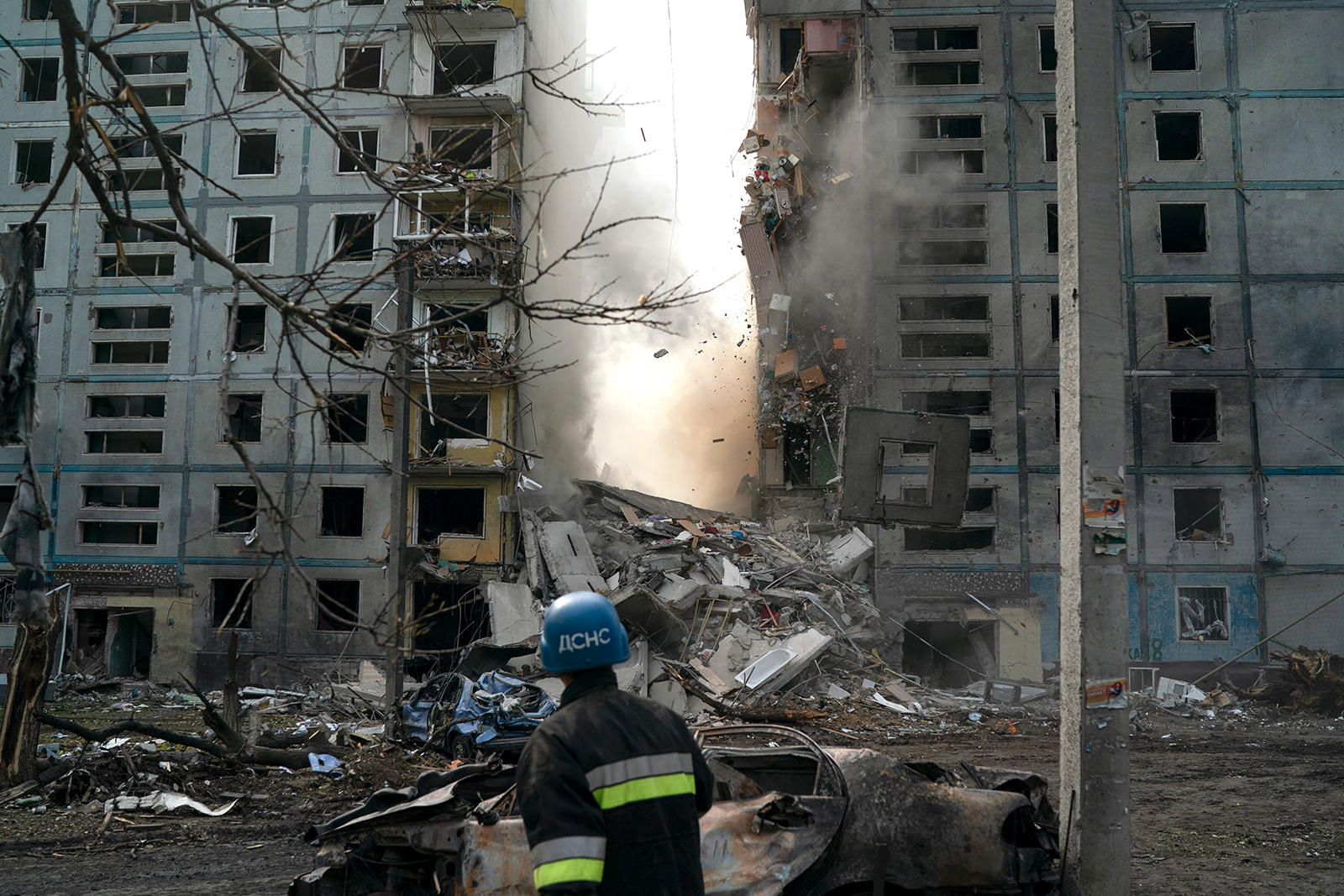 A firefighter looks at a building that was heavily damaged after a Russian attack in Zaporizhzhia on October 9.