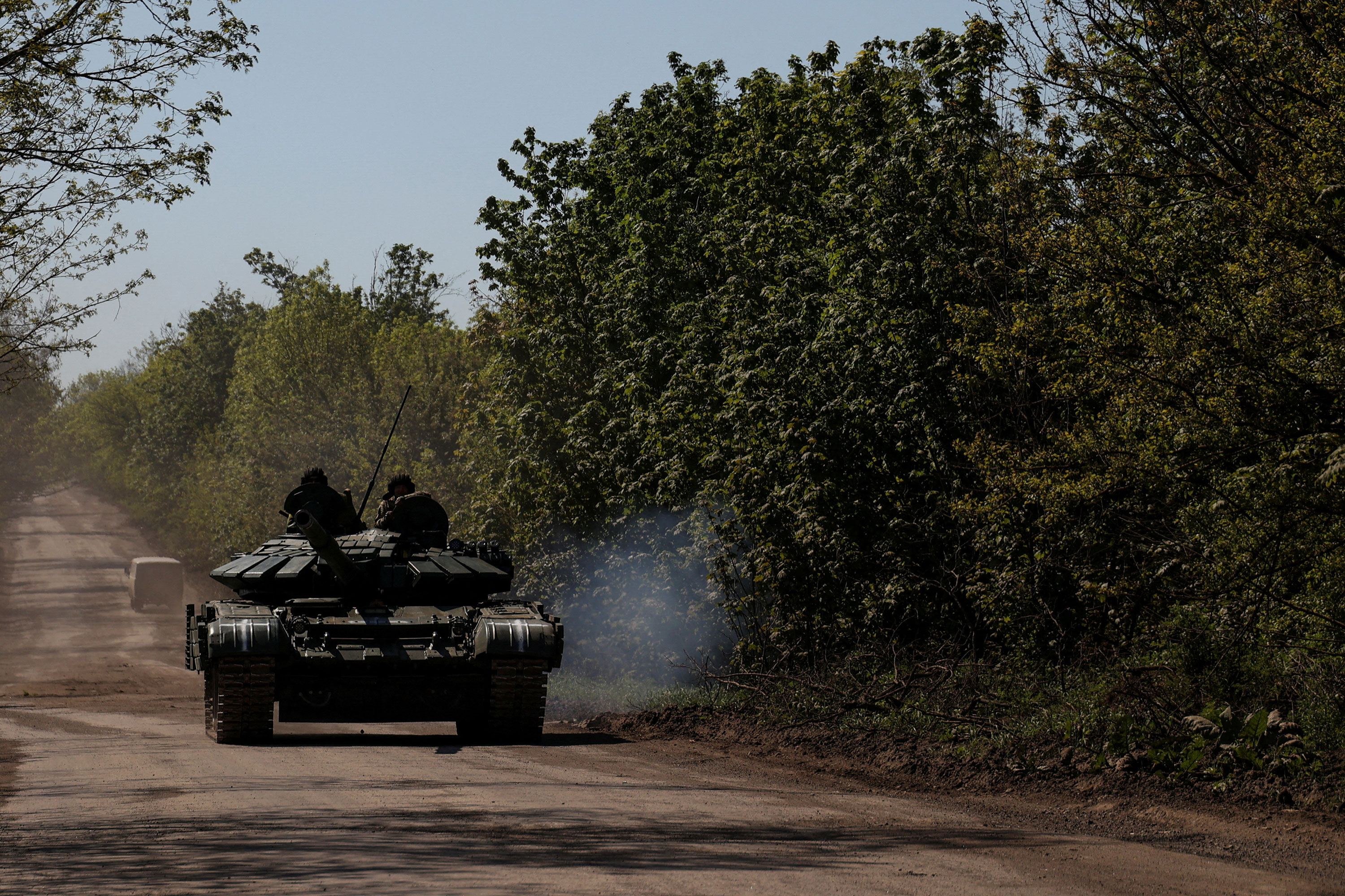 Ukrainian servicemen ride atop a tank to the frontline town of Bakhmut, Ukraine, on Friday.