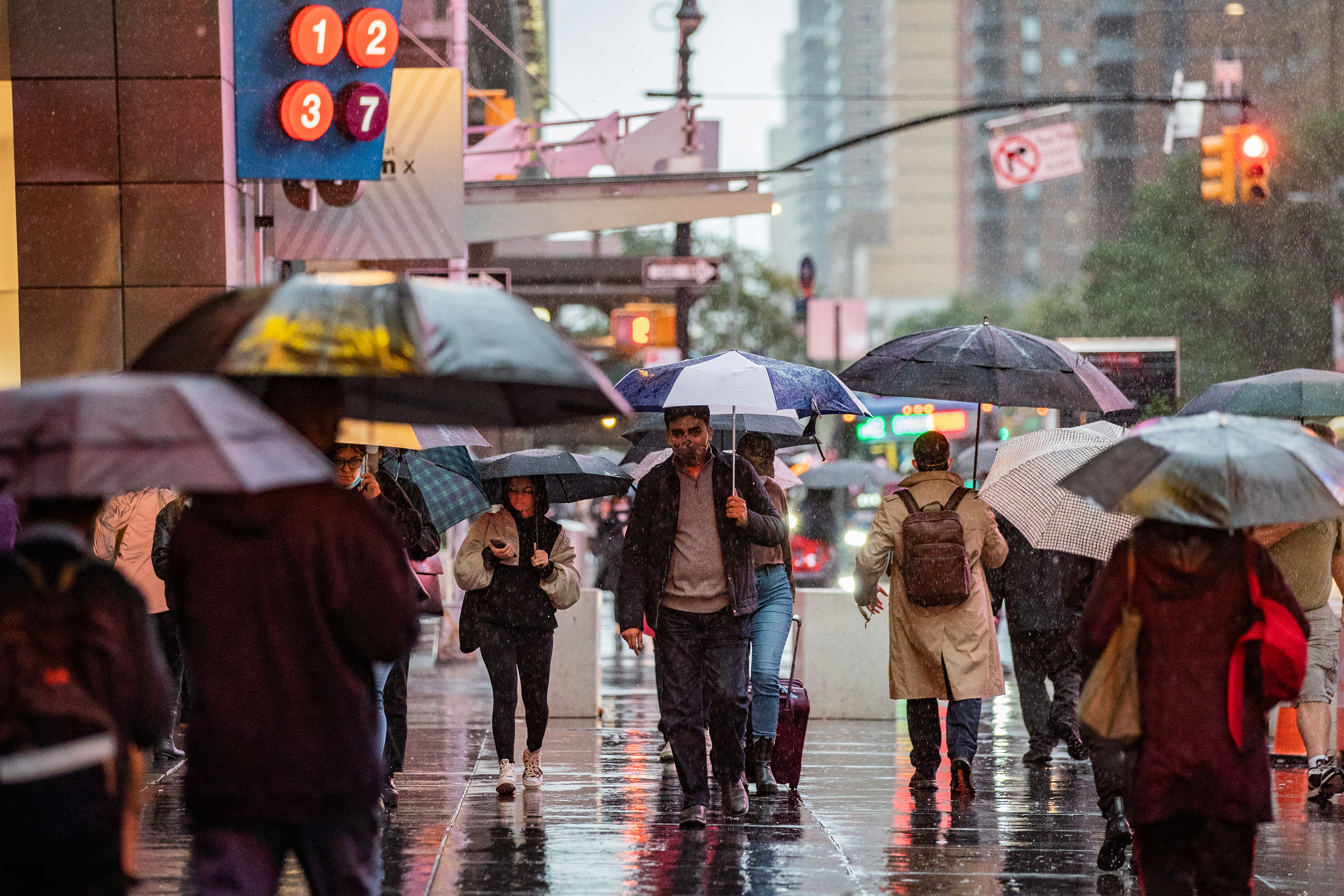Pedestrians walk through the rain in New York, on Tuesday, October 26. 
