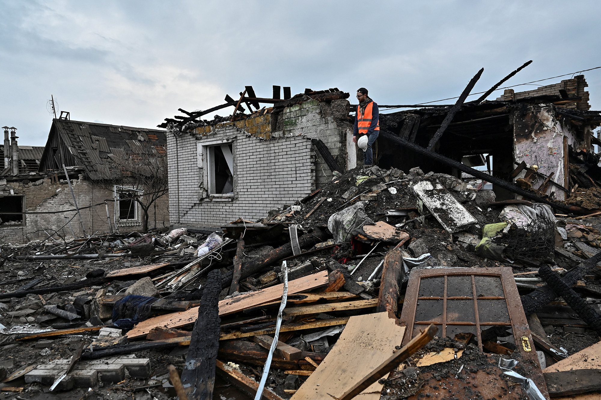 A volunteer inspects remains of a residential house damaged by a Russian missile strike in Zaporizhzhia, Ukraine, on Sunday, April 9.