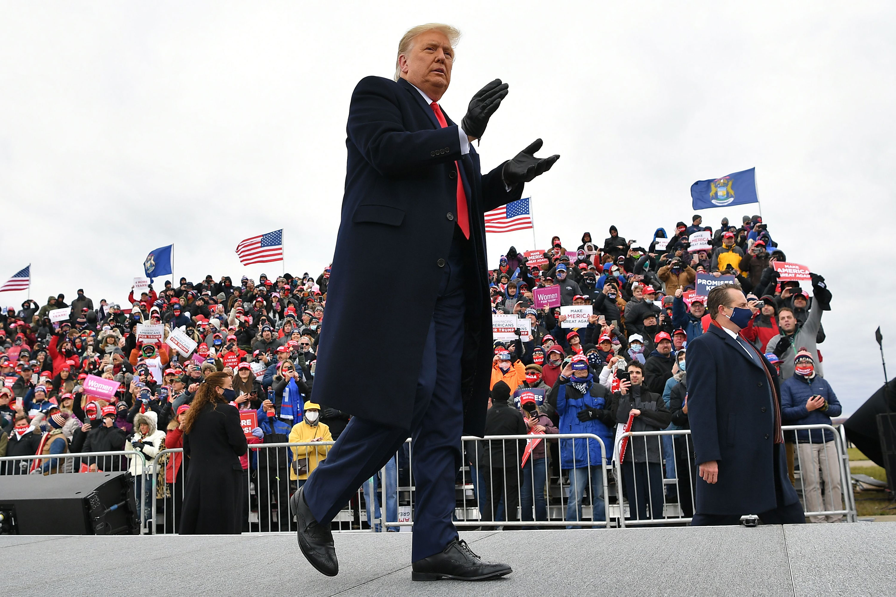 President Donald Trump walks across stage during a rally at Oakland County International Airport on October 30 in Waterford Township, Michigan. 