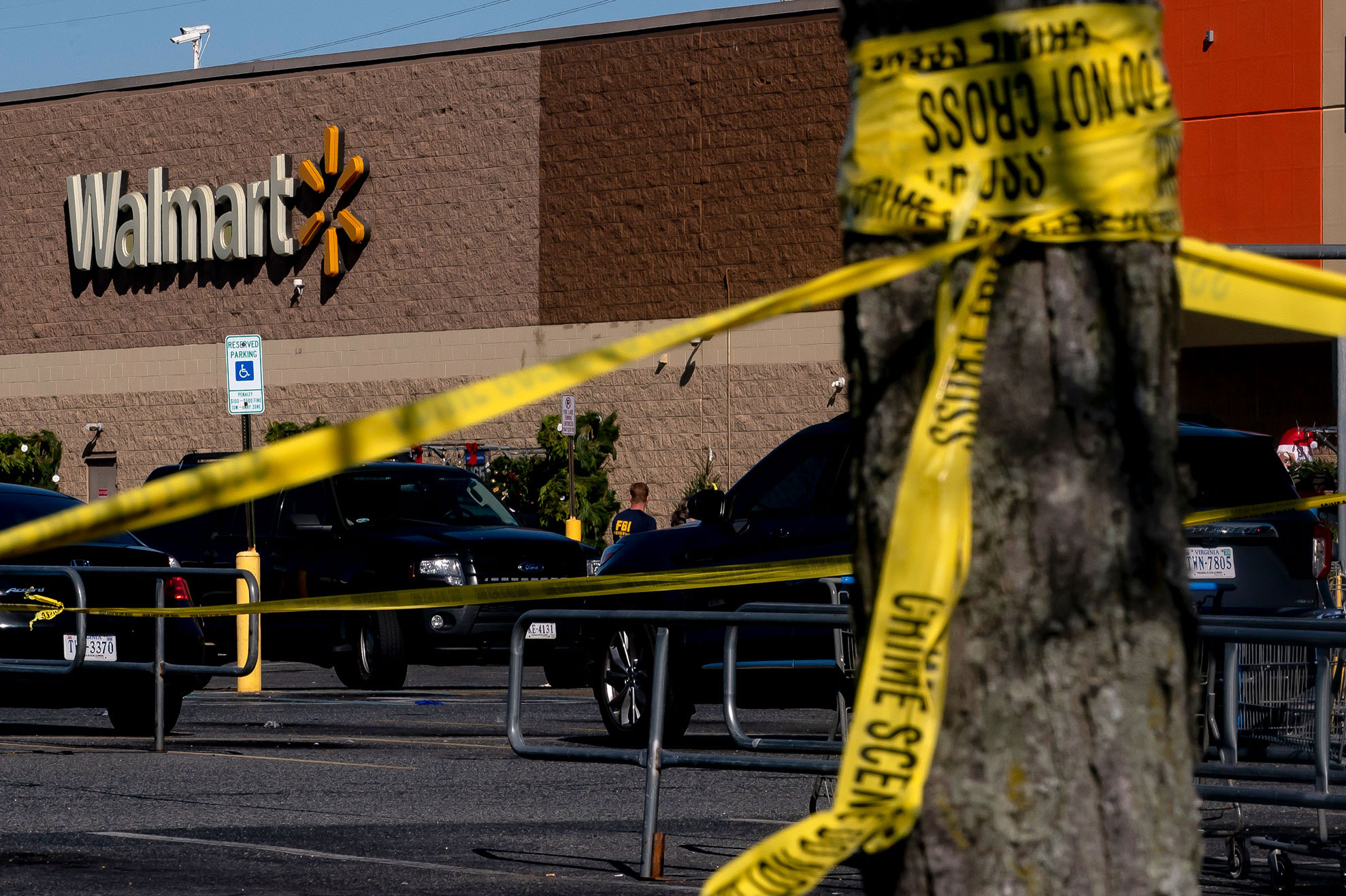 Members of law enforcement investigate the site of a fatal shooting in a Walmart on November 23, in Chesapeake, Virginia. 