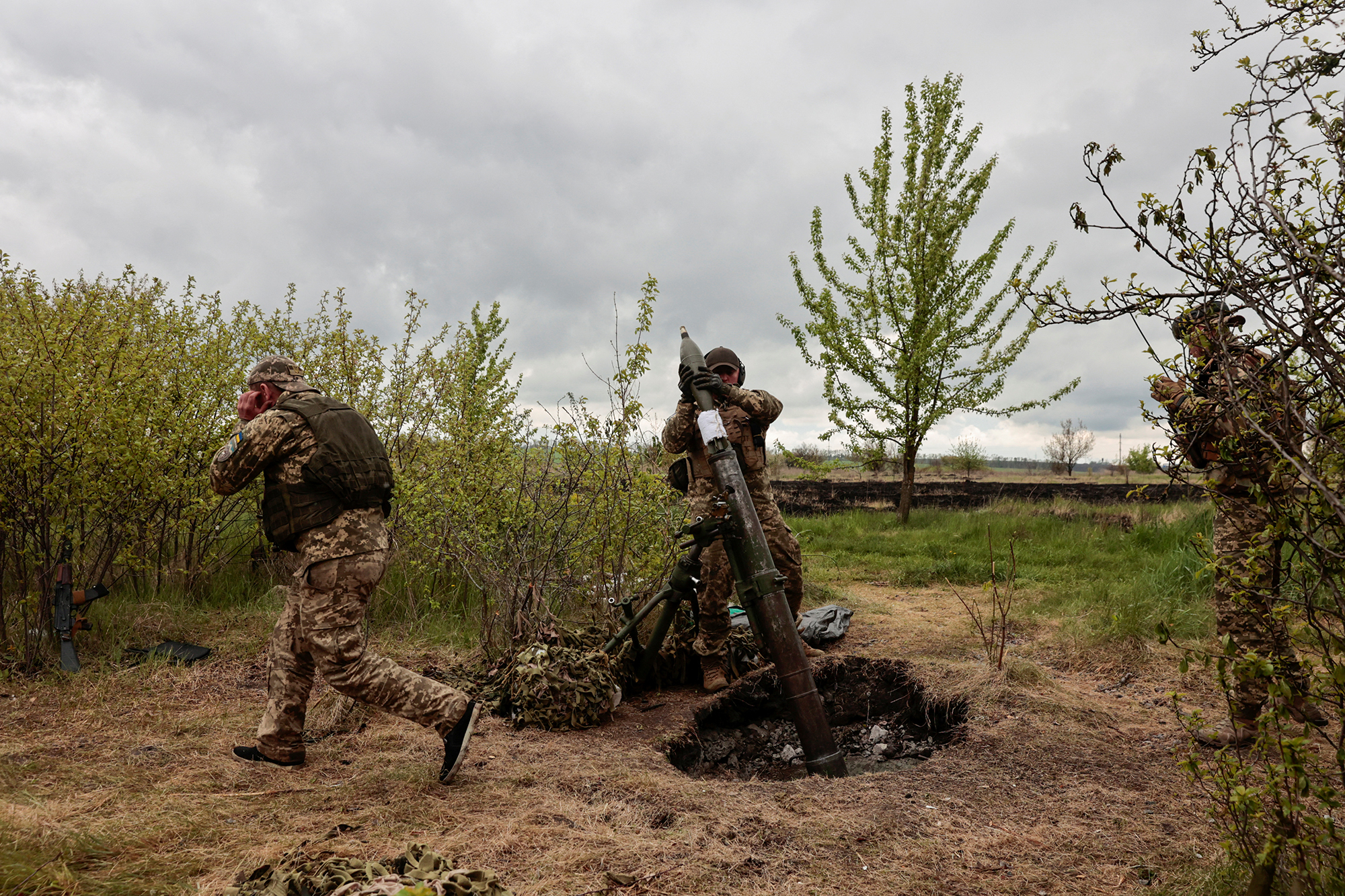 A Ukrainian serviceman loads a shell into a mortar in the Kharkiv region of Ukraine on May 9.