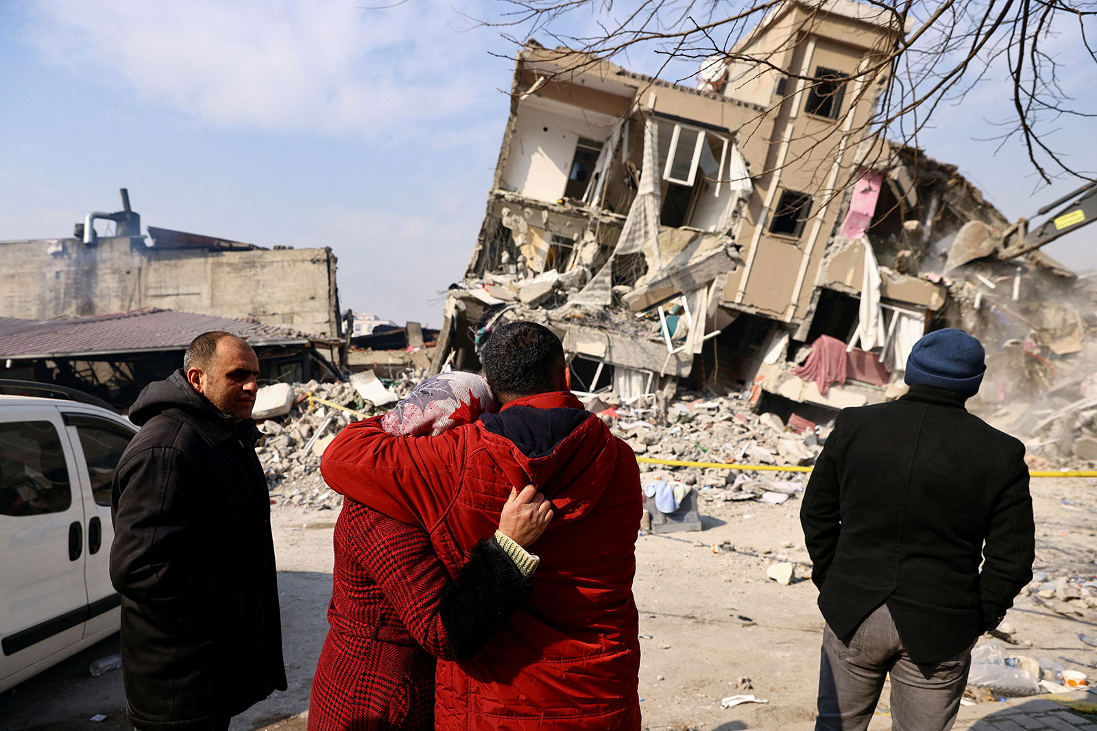 Ahmad and his wife Fatma Colakoglu stand outside of their destroyed house in Kahramanmaras, Turkey, on Friday. 