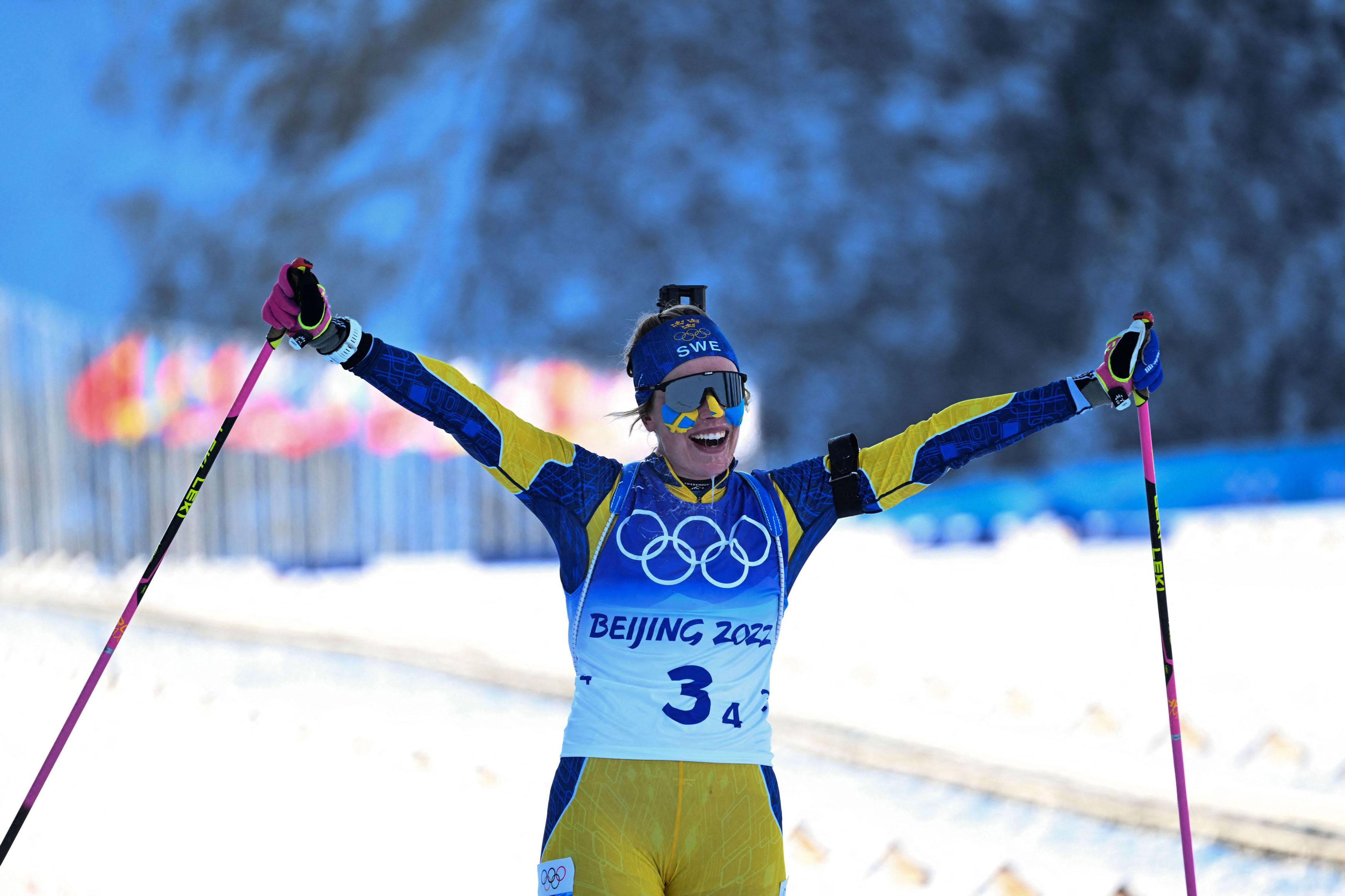 Sweden's Elvira Oberg celebrates a she crosses the finish line to win the biathlon women's 4x6km relay event, on Wednesday.