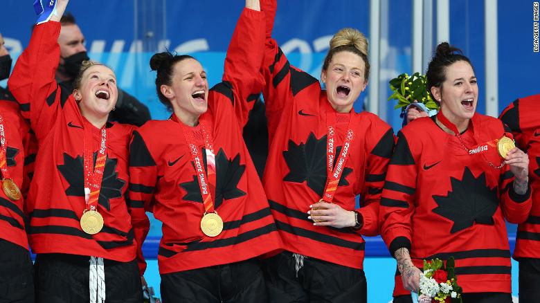 (Left to right) Sarah Fillier, Jill Saulnier, Renata Fast and Melodie Daoust celebrate with their gold medals after beating Team USA.