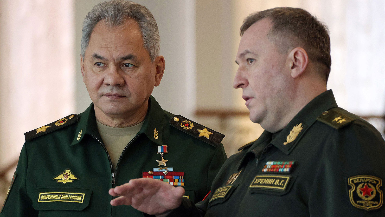 Russia's Defence Minister Sergei Shoigu, left, speaks with his Belarus counterpart Viktor Khrenin in Minsk on February 3.