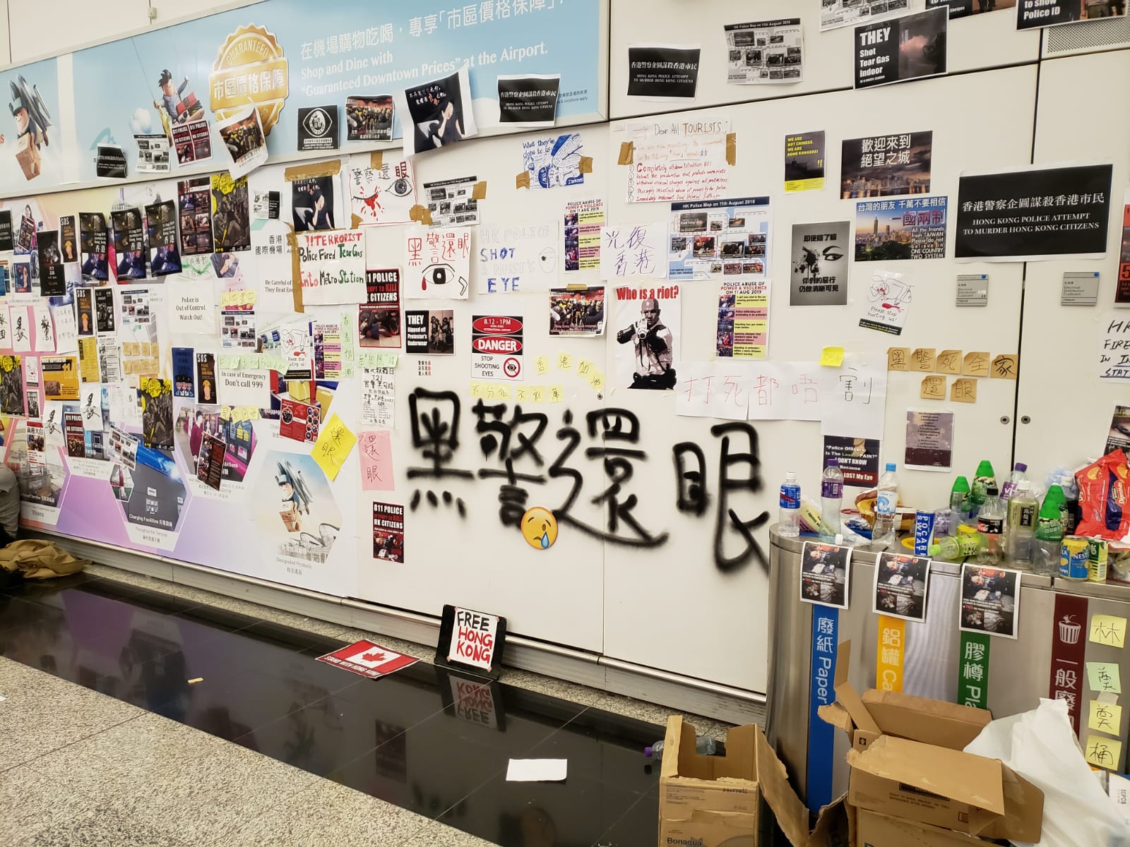 The airport walls are plastered with posters, art, and graffiti.