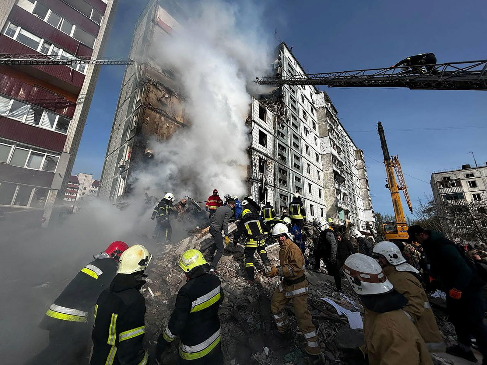 Rescuers work at the site of a residential building heavily damaged by a Russian missile in Uman, Ukraine on Friday, April 28. 