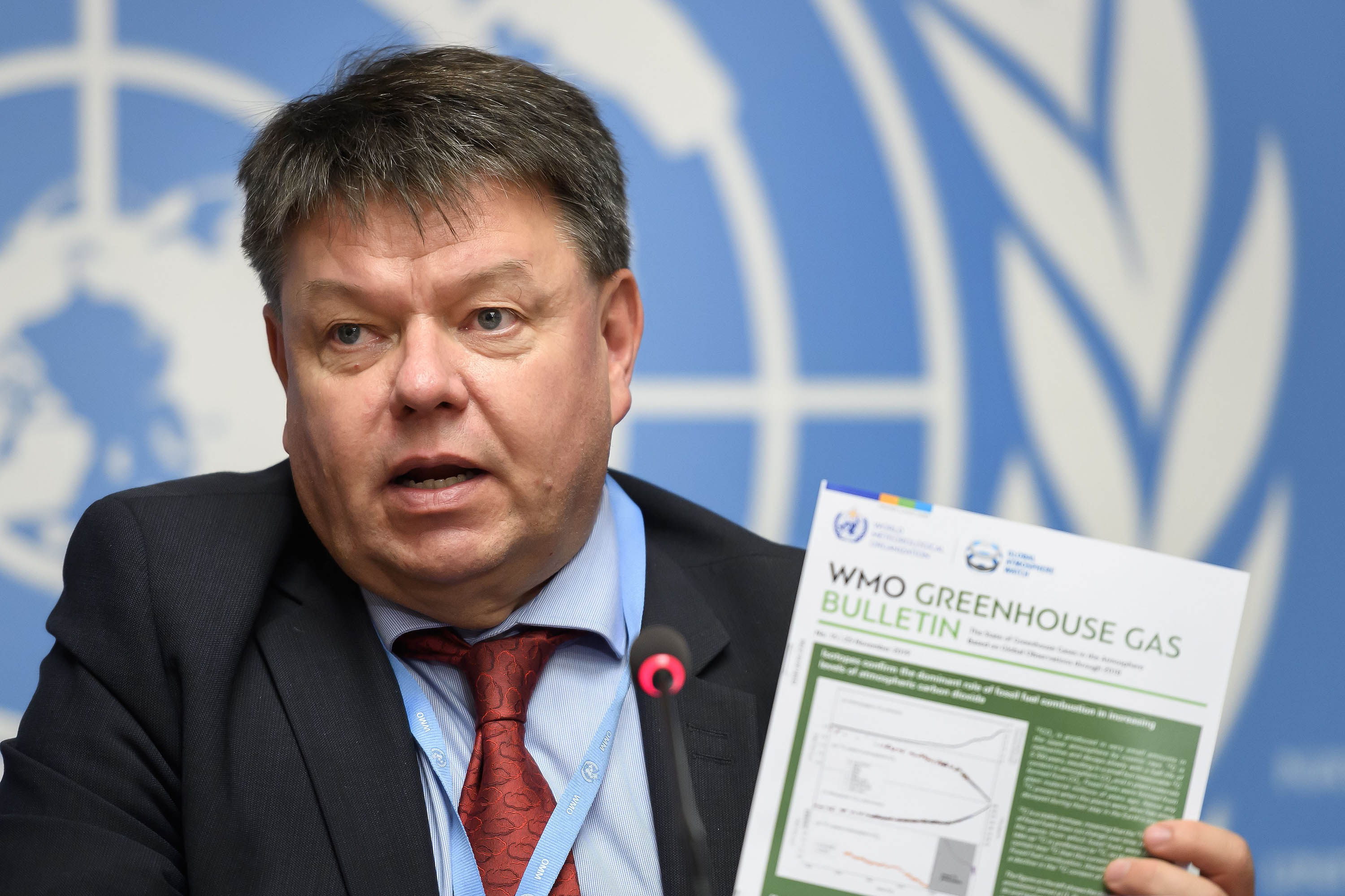 World Meteorological Organization (WMO) Secretary-General Petteri Taalas shows the Greenhouse Gas Bulletin during a press conference on atmospheric concentrations of CO2, in November 2019, in Geneva, Swizterland.
